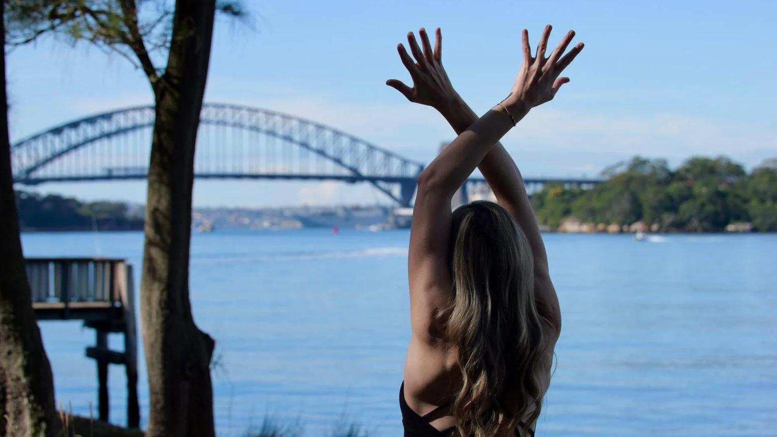 A moment of mindful movement overlooking Sydney Harbour. This image reflects the calm, balance, and connection at the heart of Flow Republic's yoga and wellness classes, helping students find the right class to support their practice.