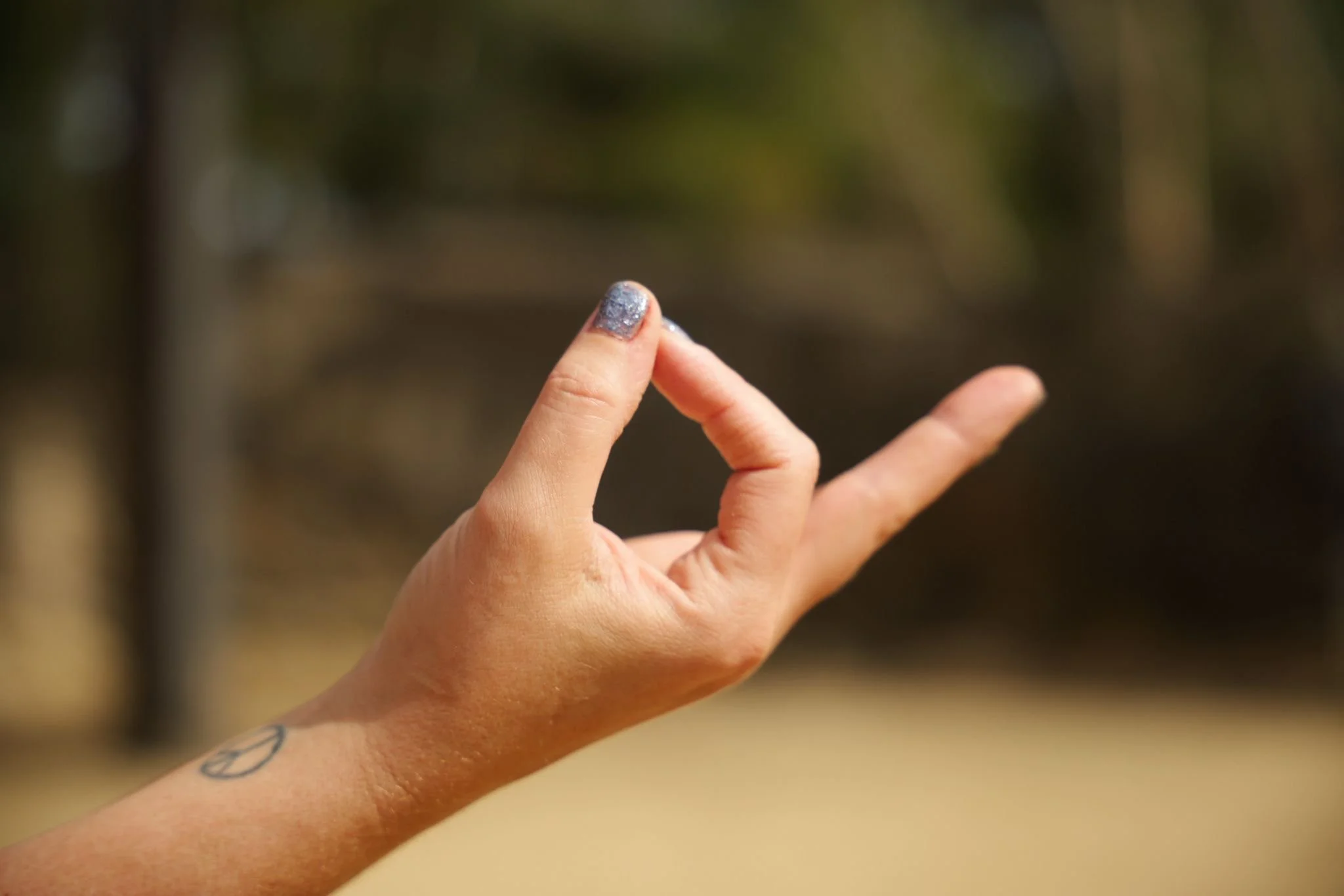 Hand forming a meditation mudra, representing mindfulness, meditation and wellbeing at Flow Republic in Rozelle.
