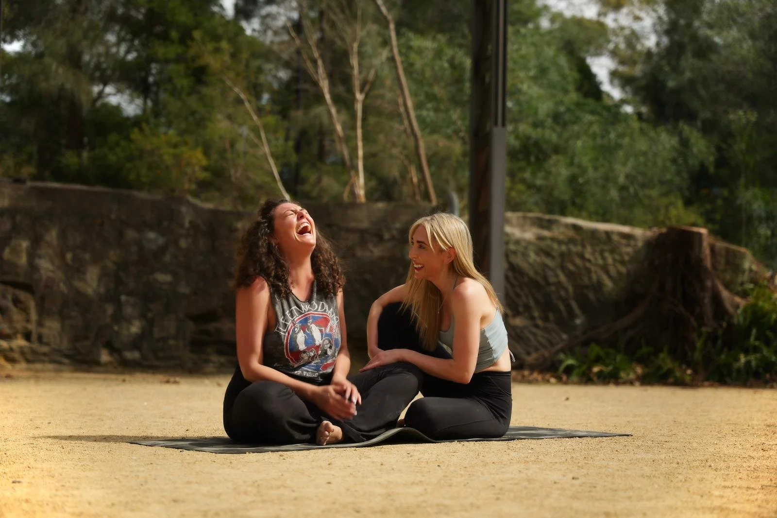 Christina and Corinne of the Flow Republic sharing a moment of connection and laughter, reflecting the welcoming atmosphere and sense of belonging at the Rozelle, Sydney, yoga studio.