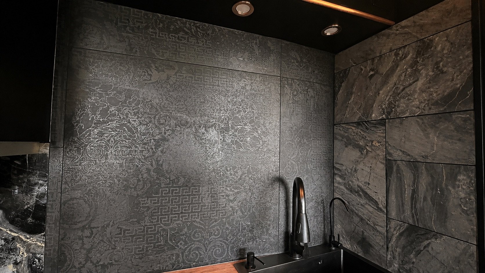 Decorative Versace Ceramics tiles integrated with dark cabinetry and timber in the K·HAUS kitchen