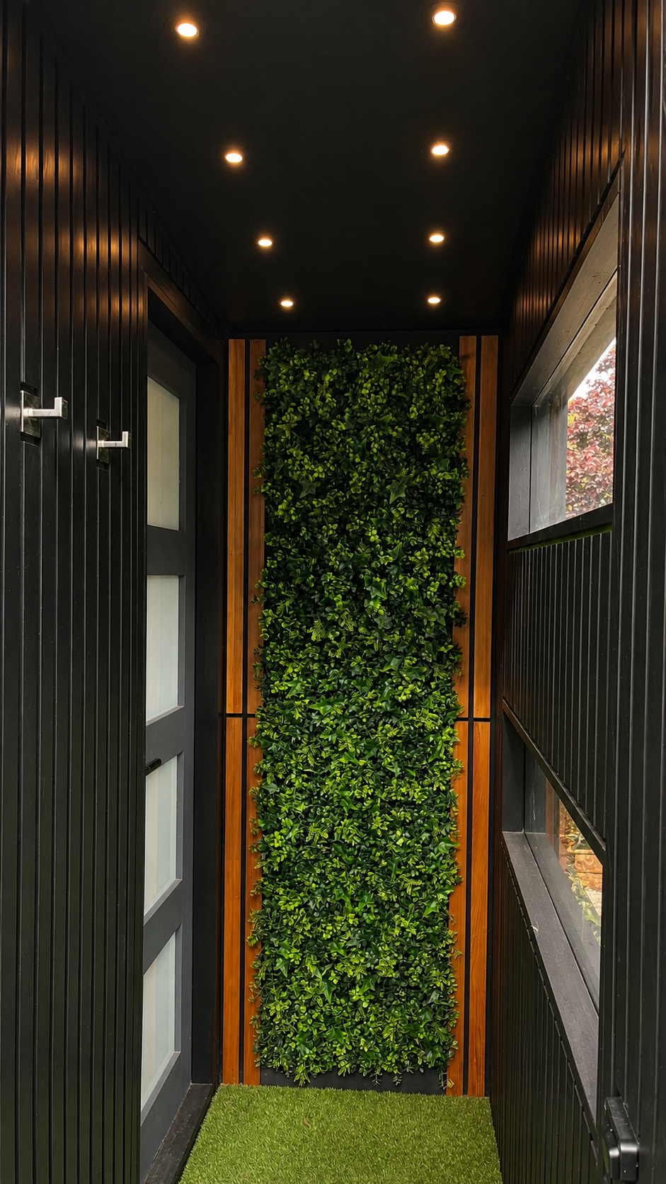 Living wall and concealed lighting within the private entrance to the PLUVIA outdoor shower room