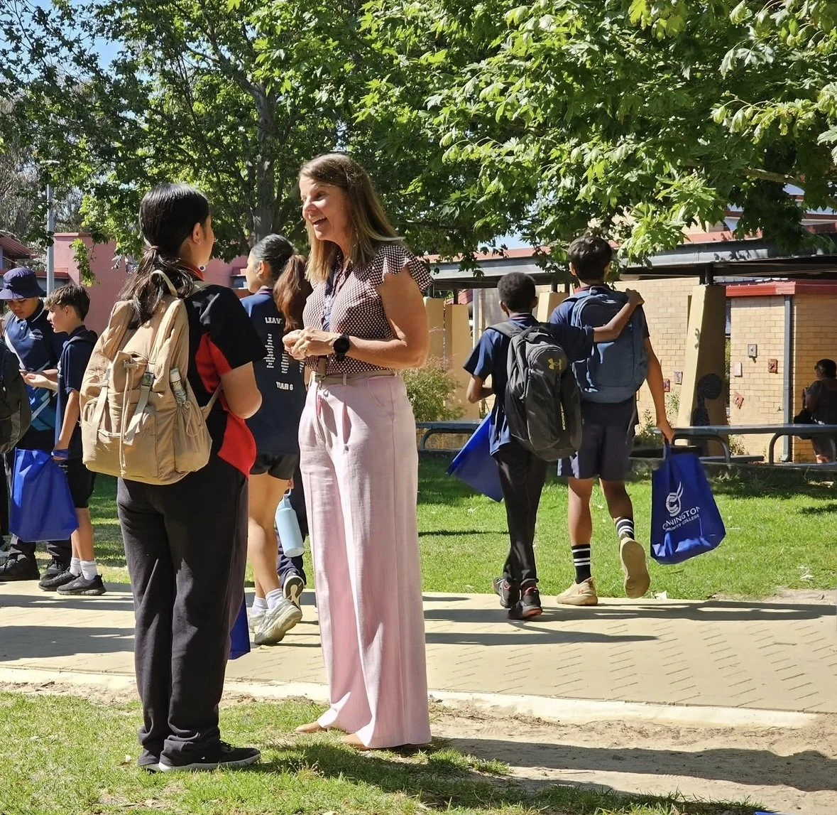 Rebecca Kirkwood speaking with students at school