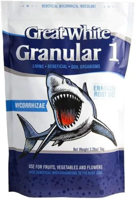 A bag of Great White Granular 1 beneficial microbial inoculant for soil bacteria, featuring a cartoon shark with its mouth wide open, showing sharp teeth. The bag indicates it is used for fruits, vegetables, and flowers to enhance root zone microorganisms, with a net weight of 2 pounds.