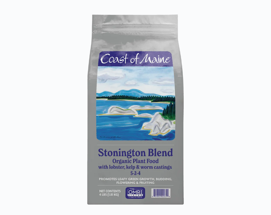 A bag of Coast of Maine Stonington Blend organic plant food with lobster, kelp, and worm castings, featuring an illustration of a coastal landscape with water, rocks, trees, and mountains.