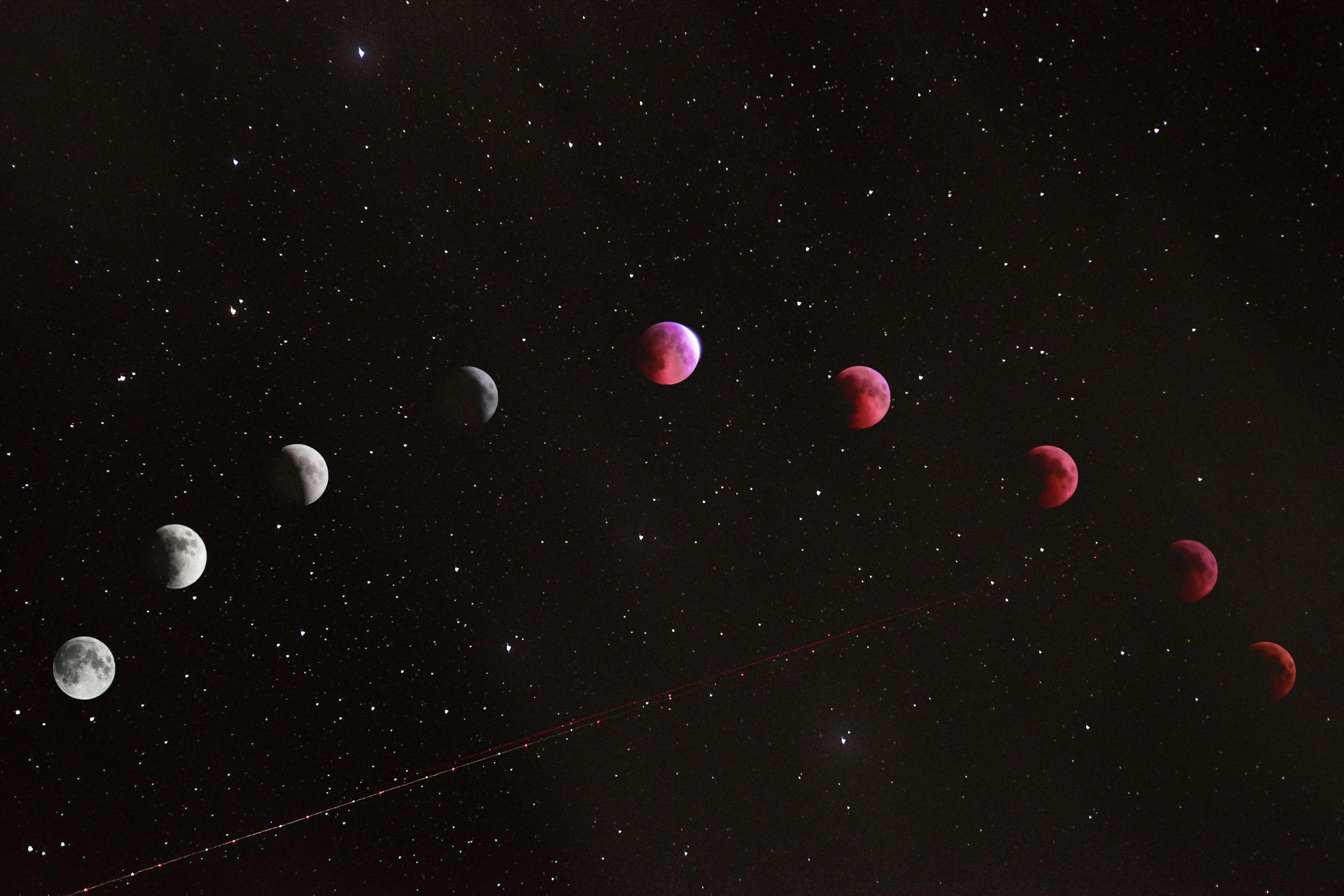 Sequence of images capturing the lunar eclipse at night, showing the moon in various stages of red and grey colors against a starry sky.