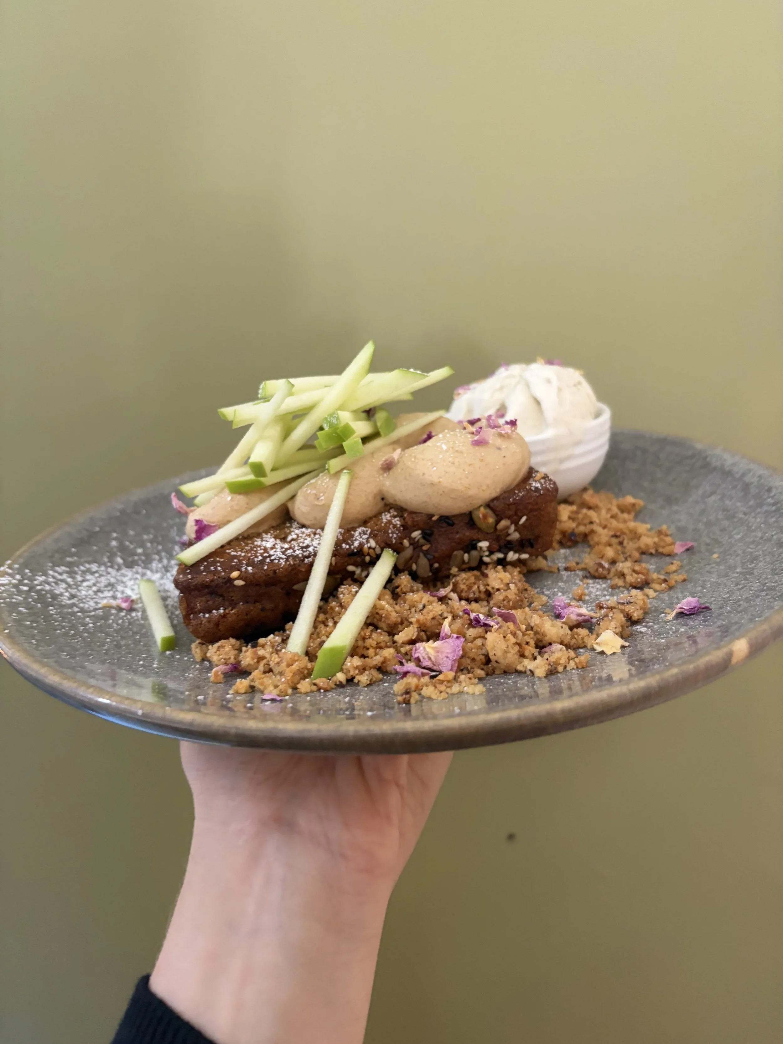 Sweet breakfast option or dessert. Melbourne style toasted banana bread with banana white chocolate ganache, Golden North vanilla bean ice cream, dried rose petals, fresh julienne apple and maple syrup dusted in icing sugar