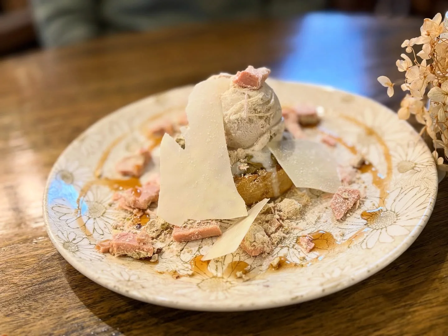 Dessert with Golden North vanilla bean ice cream, white chocolate shards, pink raspberry white chocolate and fairy floss crumble with pistachio praline, Essential Creme Pistachio spread on a Posh buttermilk crumpet dusted in icing sugar