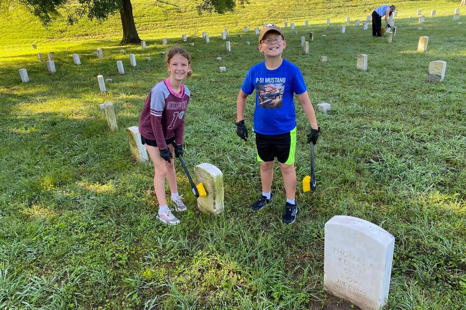 Cleaning headstones in the Vicksburg National Cemetery.