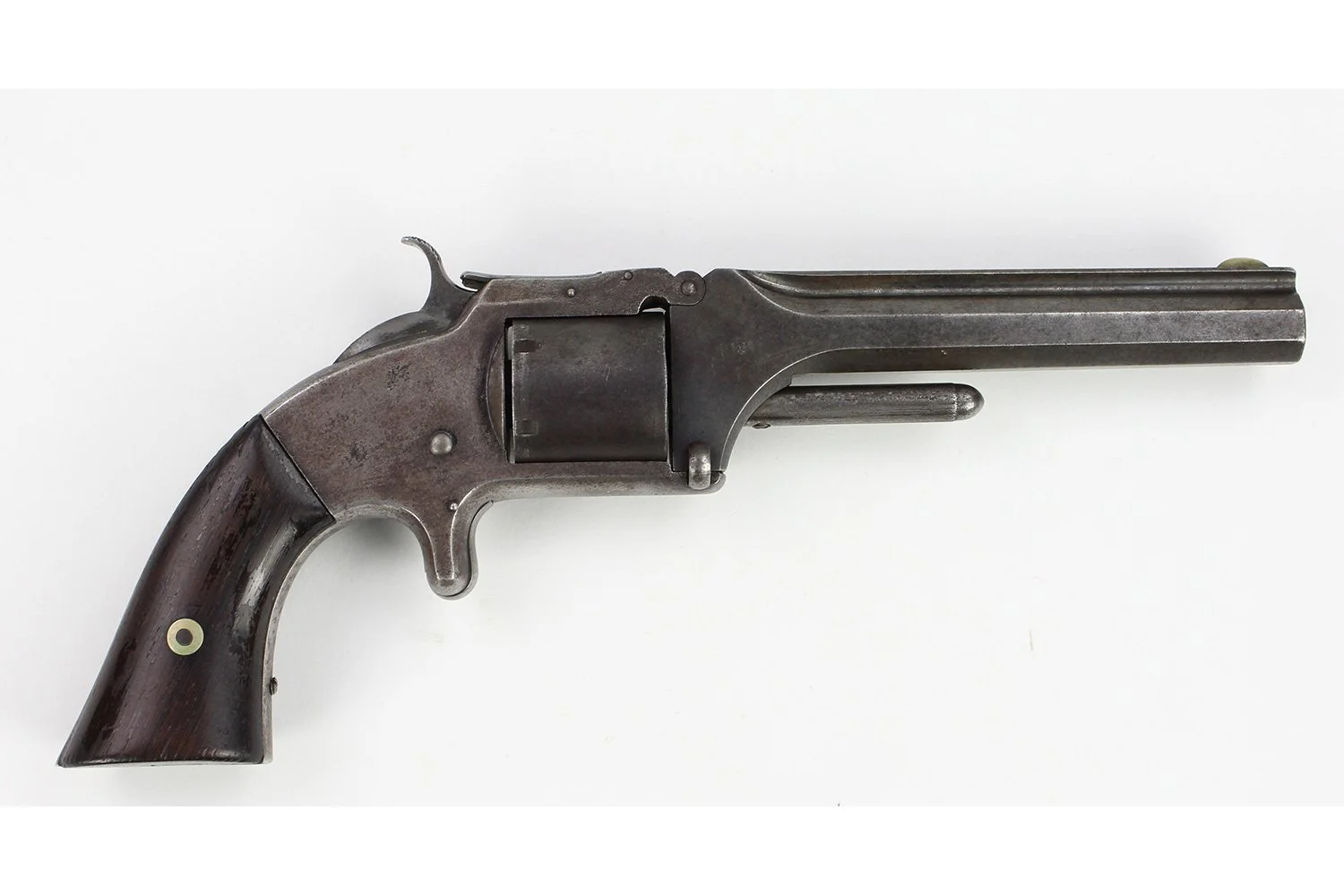 Old-fashioned black revolver with a long barrel on a white background.