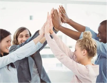 Group of diverse colleagues giving each other a high five in an office setting. Concord NC promises12 DWI