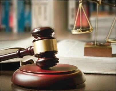 Gavel resting on a sound block, with a blurred legal book and a scale of justice in the background. Concord NC promises12 DWI