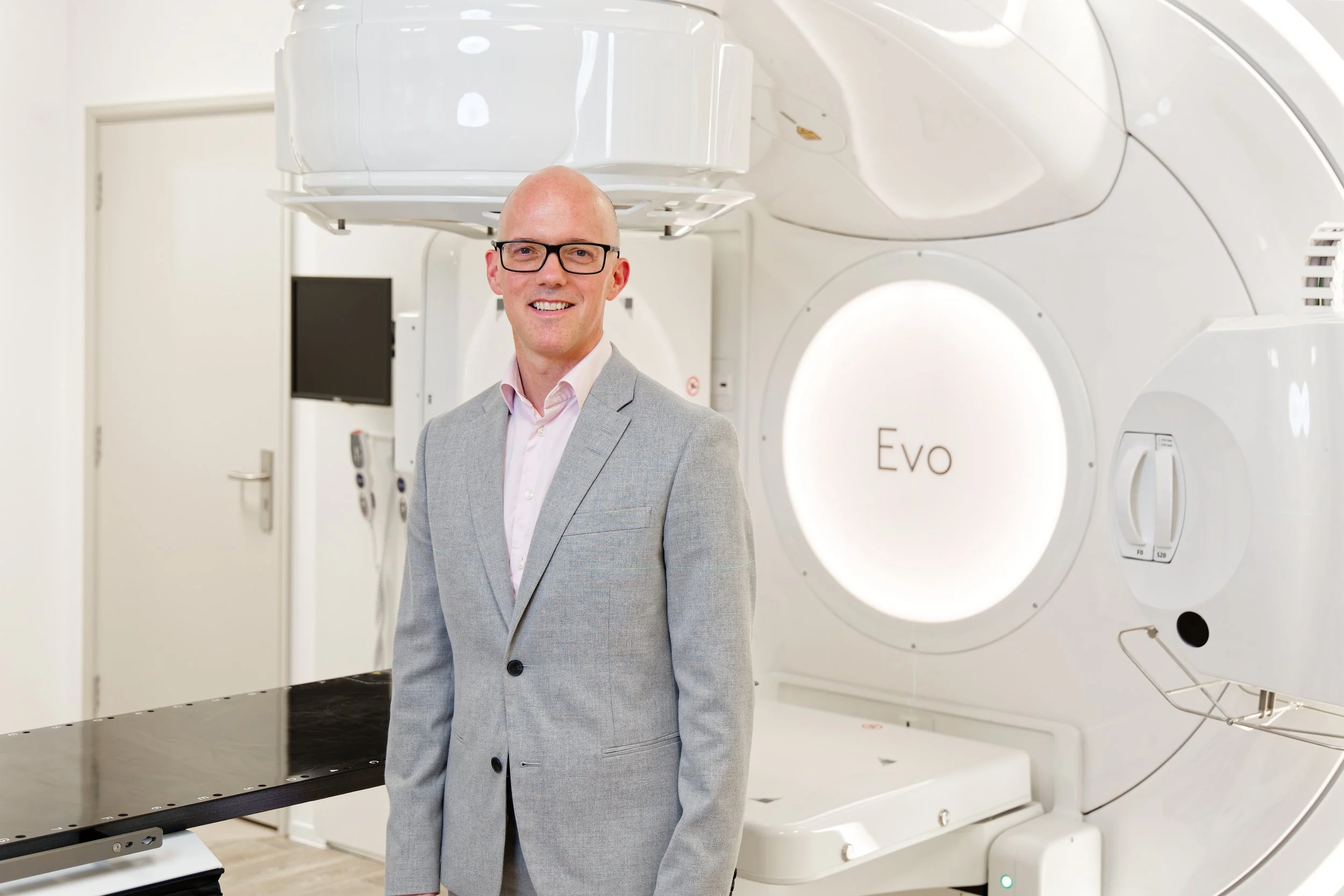 Healthcare photography man wearing gray suit and MRI scanner