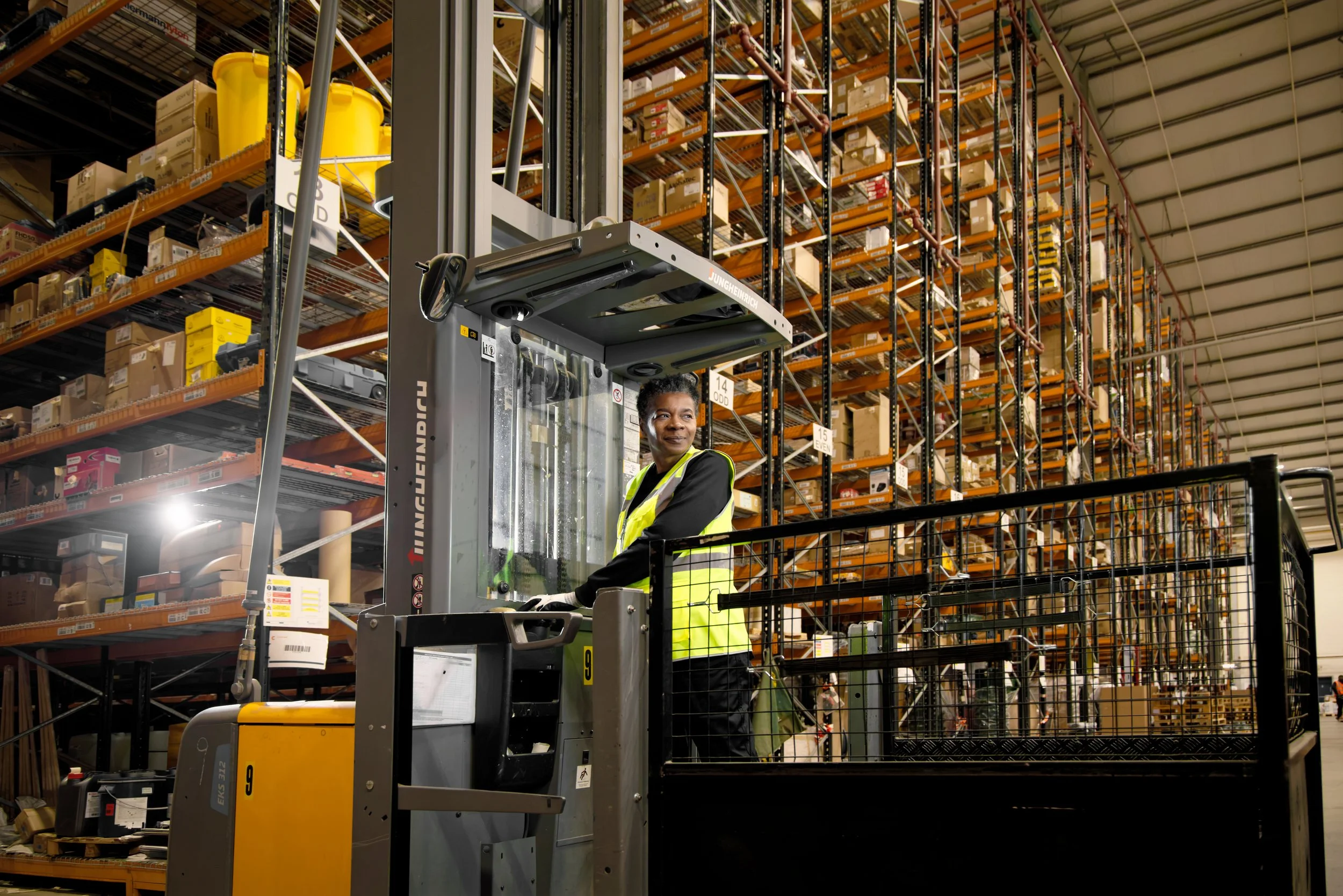 Warehouse photography woman in a picker truck