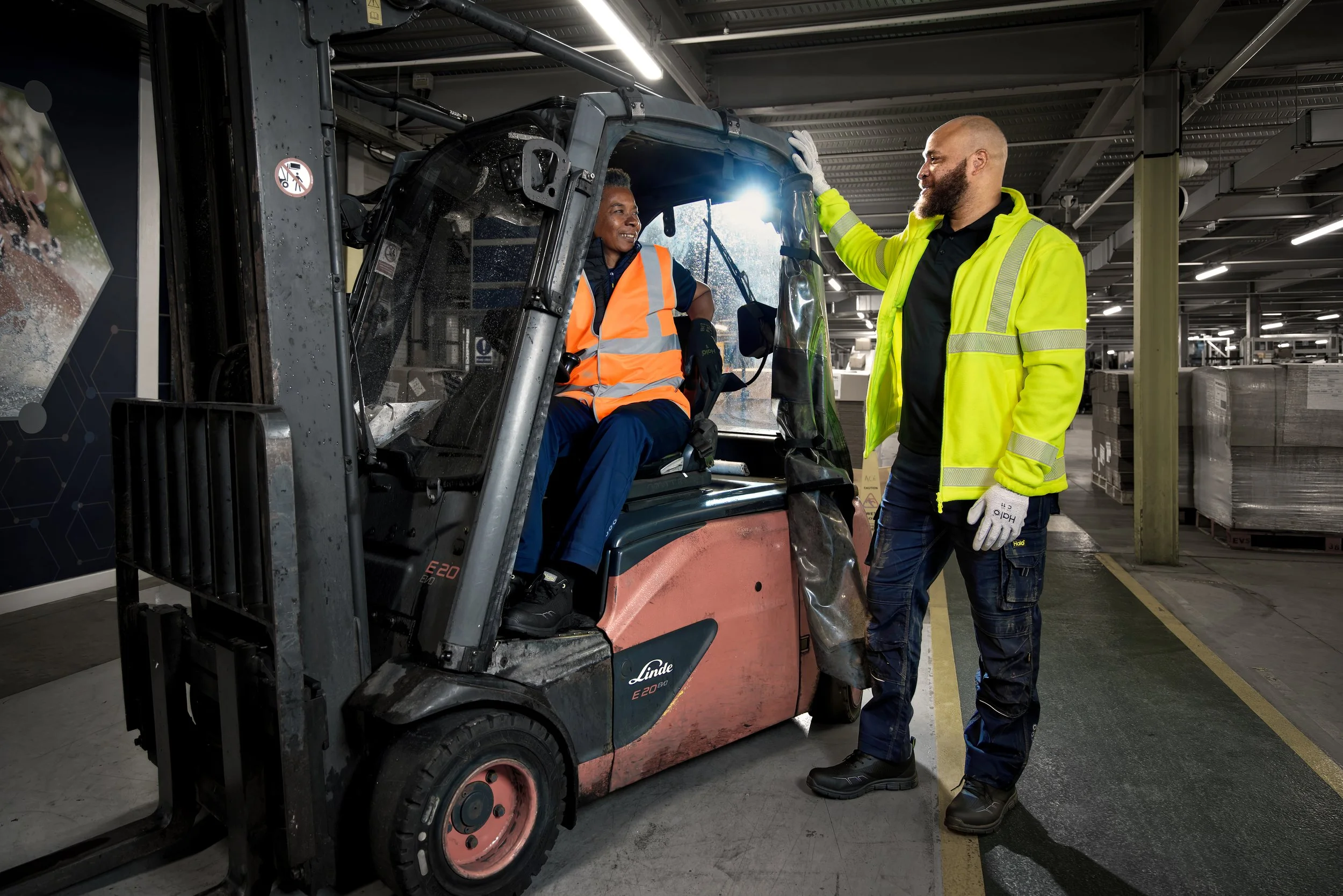 Warehouse photography man and woman with forklift