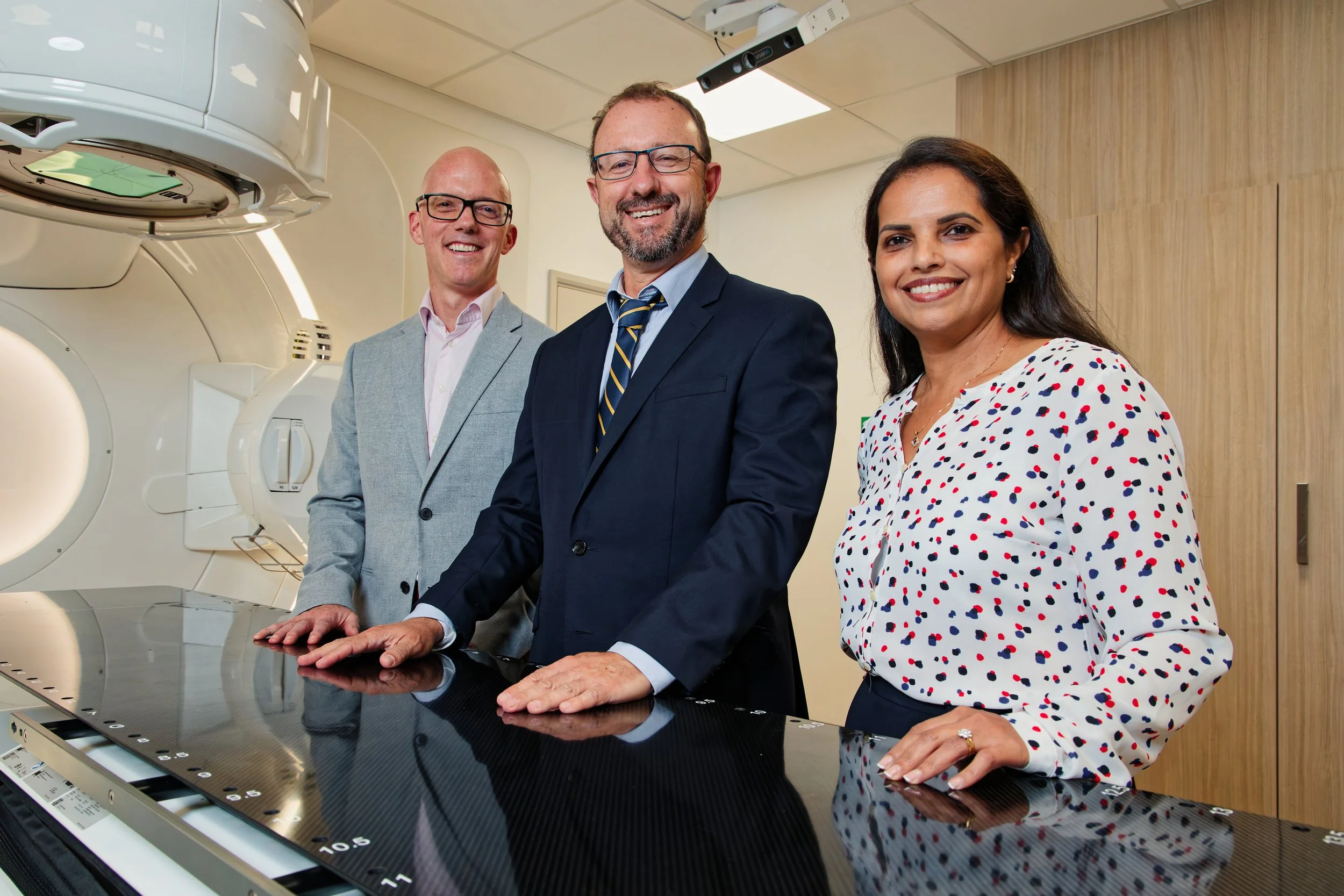 Three doctors in a MRI scanner room