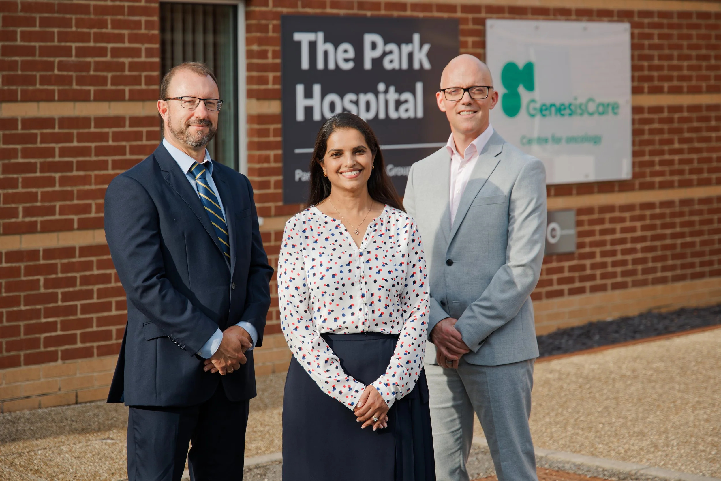 Three doctors posing outside The Park Hospital clinic