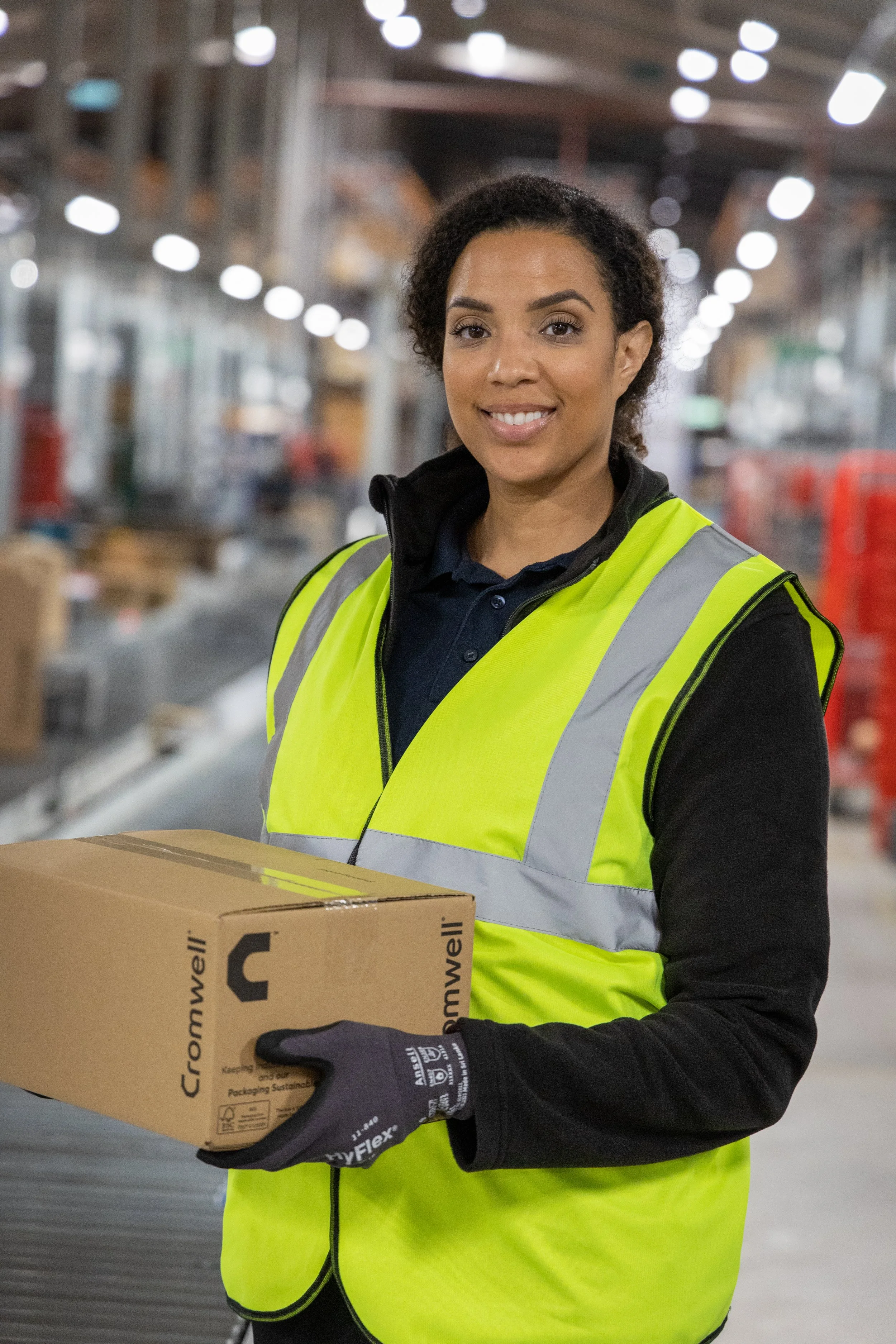Warehouse photography woman holding box to deliver