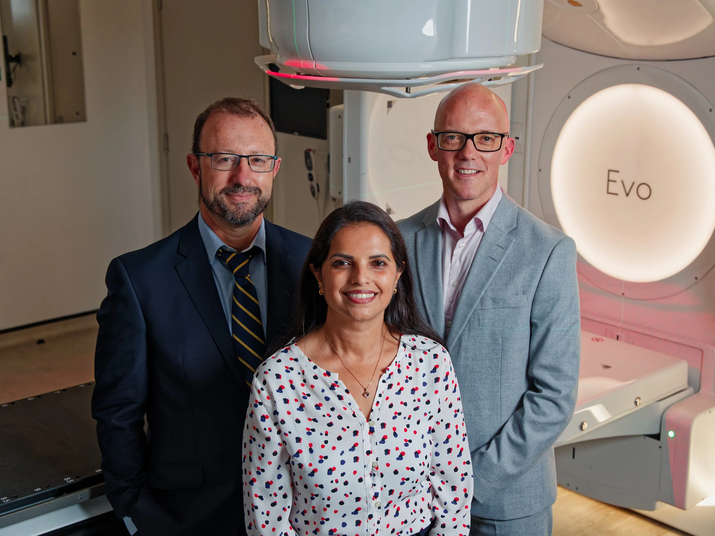 Three doctors in a Evo MRI scanner room