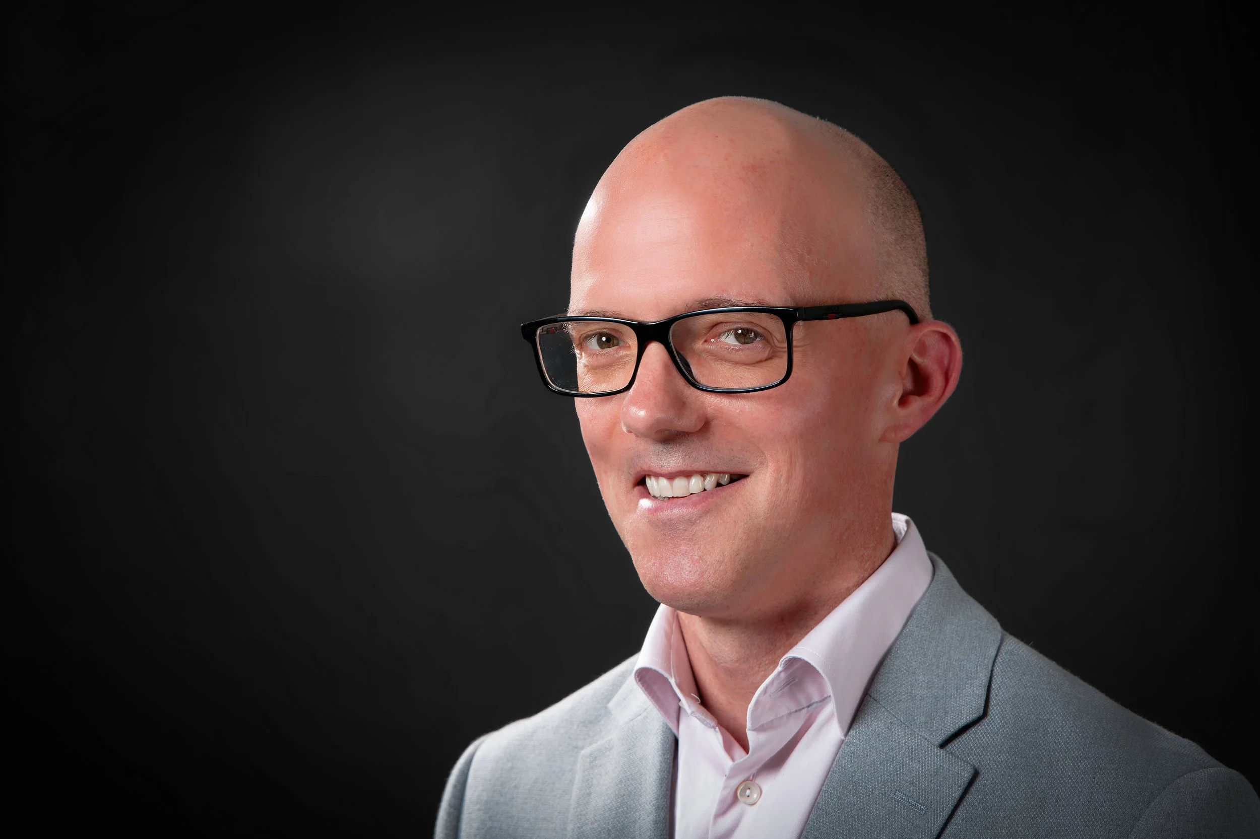 Headshot of a man wearing glasses