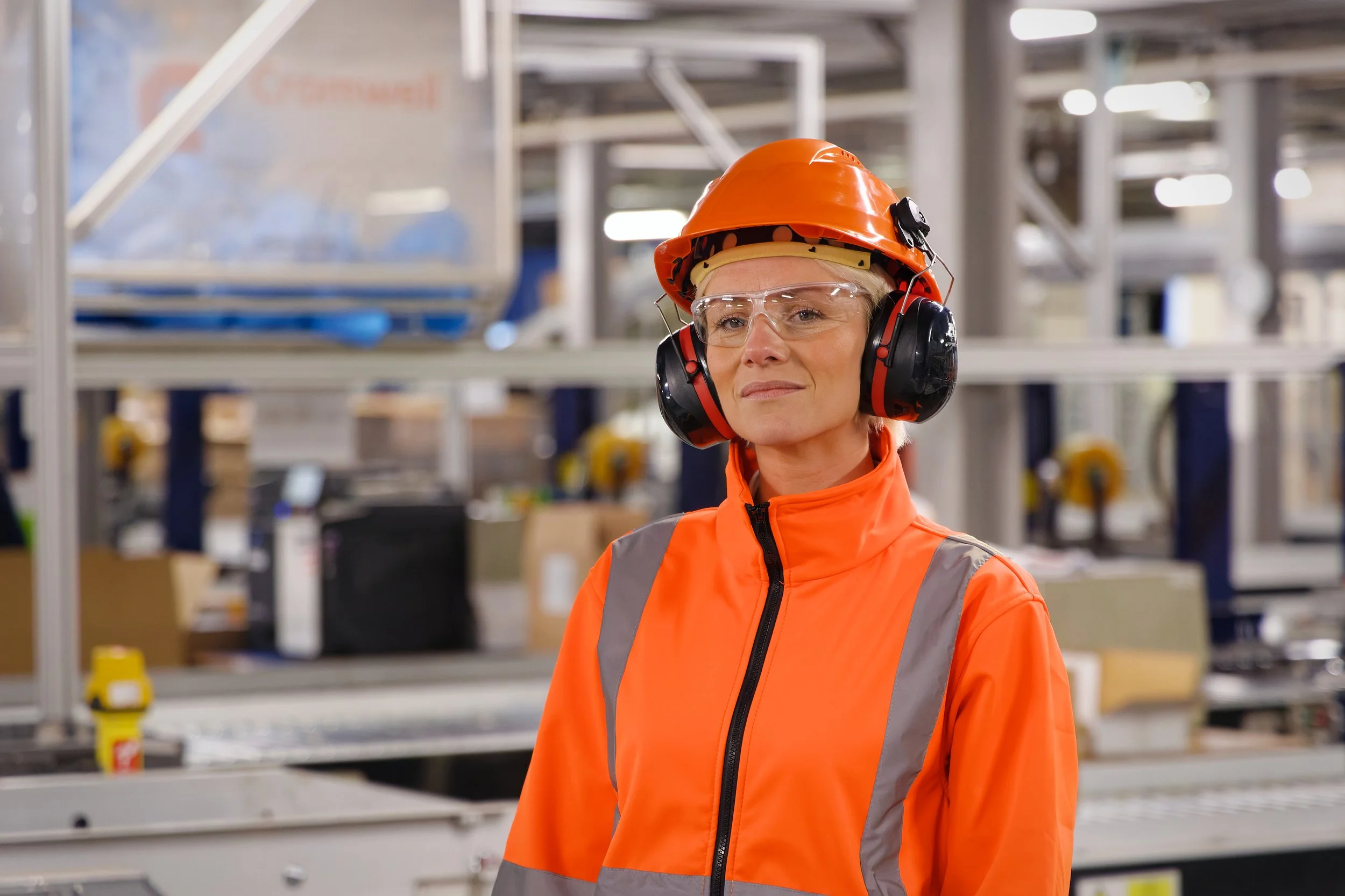 Industrial photography woman orange PPE