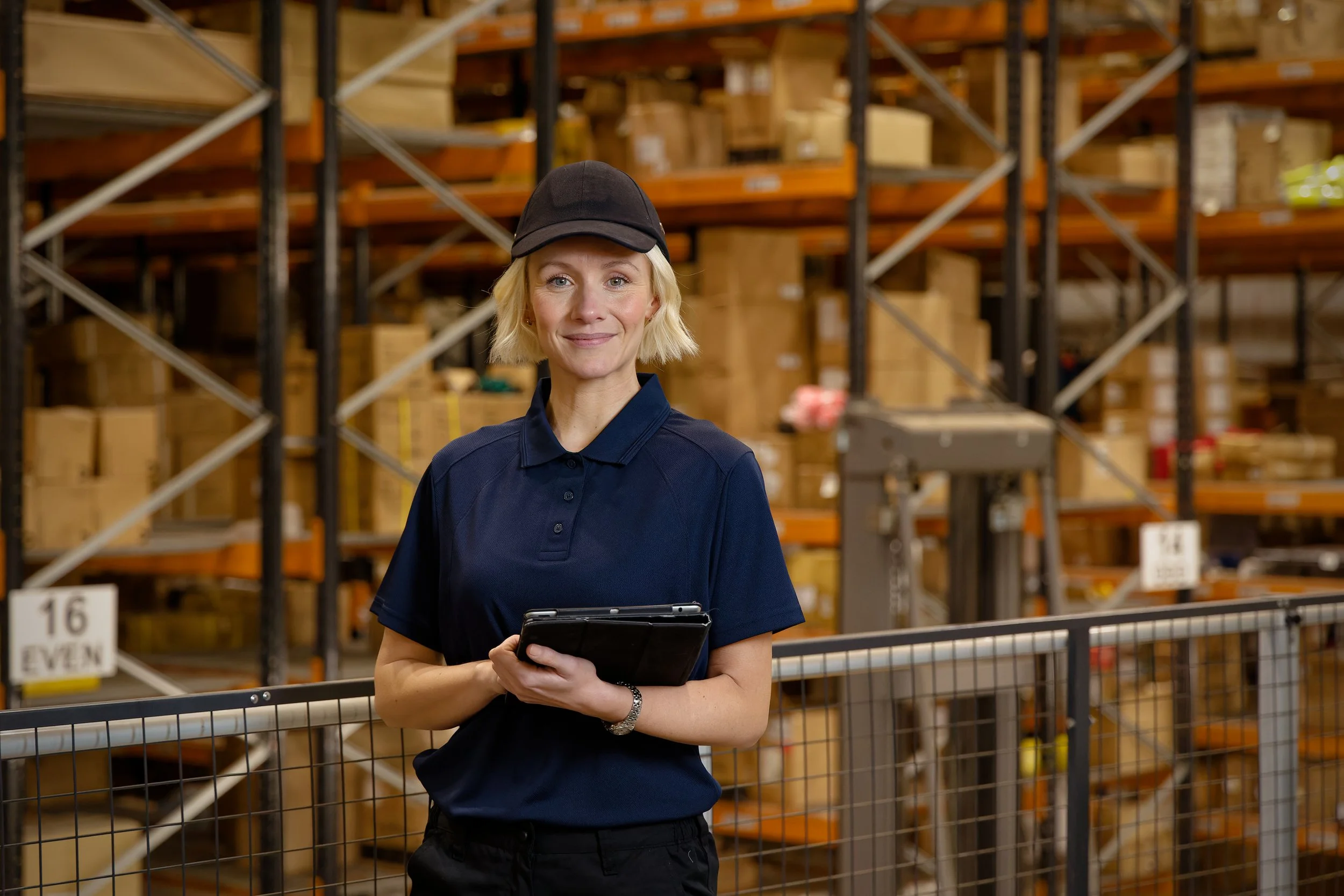 Warehouse photography woman with cap and clipboard