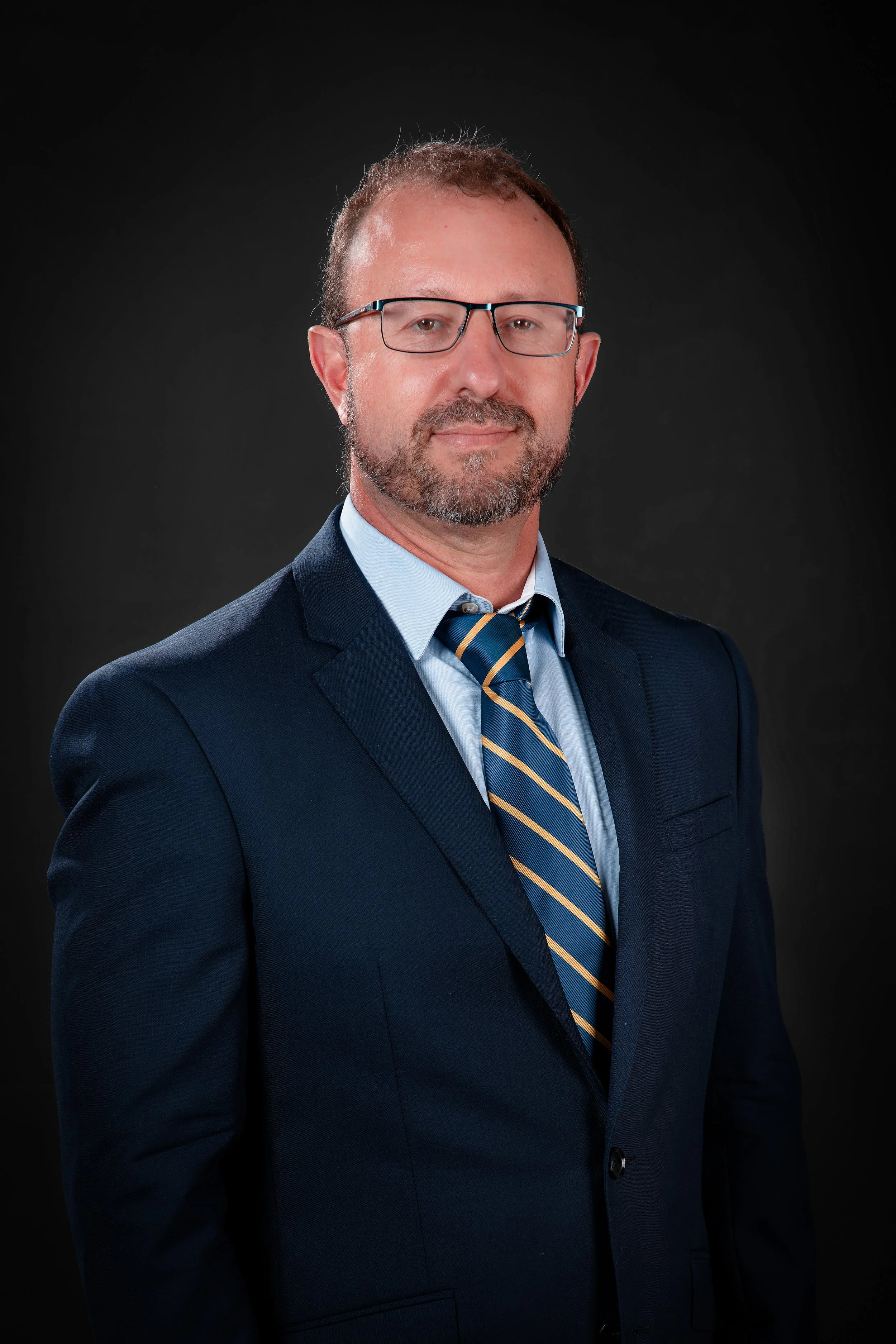 Headshot of a man wearing a suit