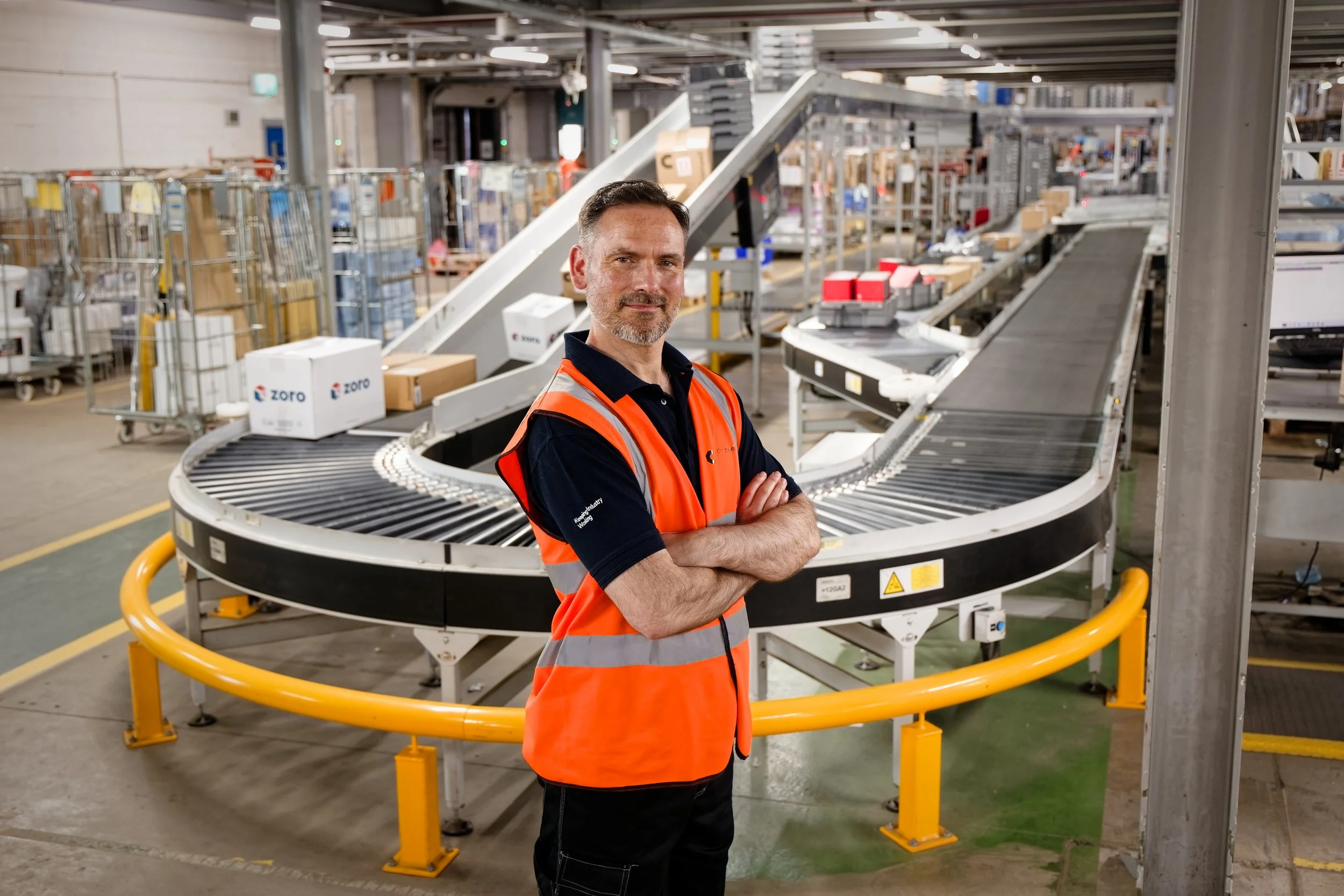 Warehouse photography man with conveyor belt behind