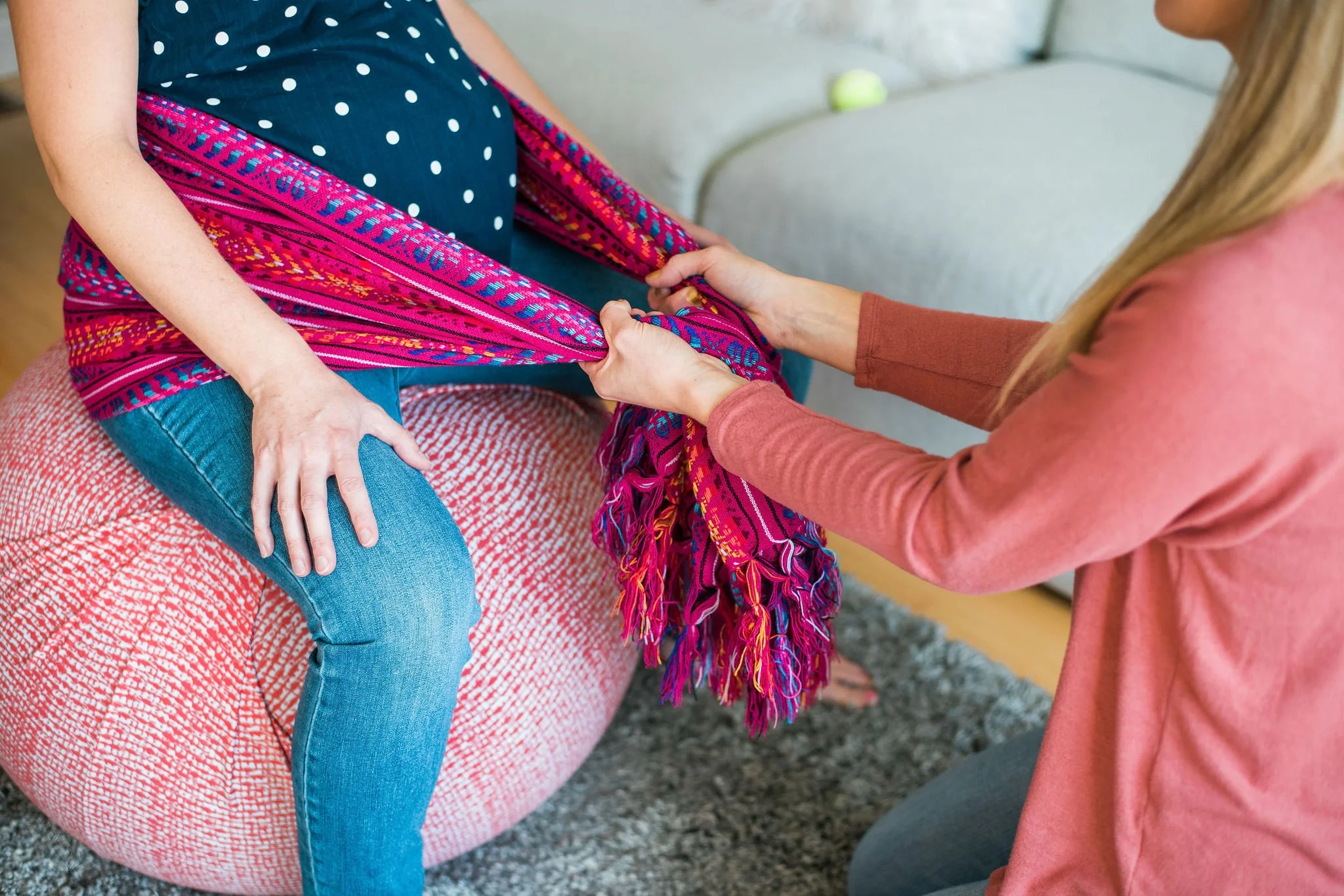 Midwife teaching pregnancy comfort techniques during a prenatal care visit in Murrieta, California