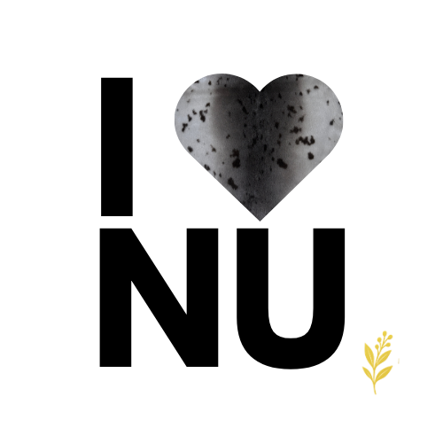 A heart-shaped cookie with dark chocolate chips and a paper note with a yellow clip attached.