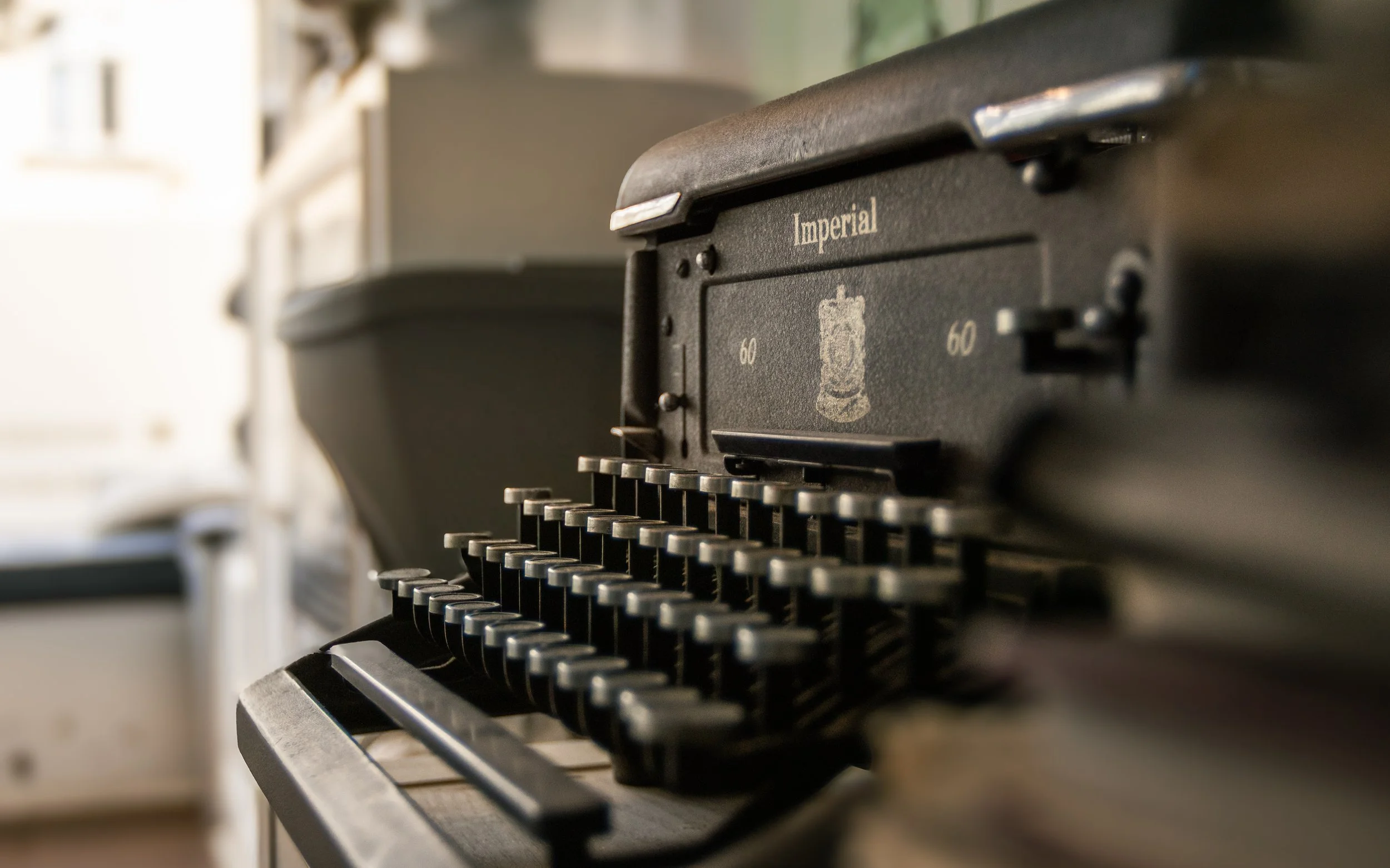 Close-up of a vintage black Imperial typewriter showing the keys and part of the carriage.