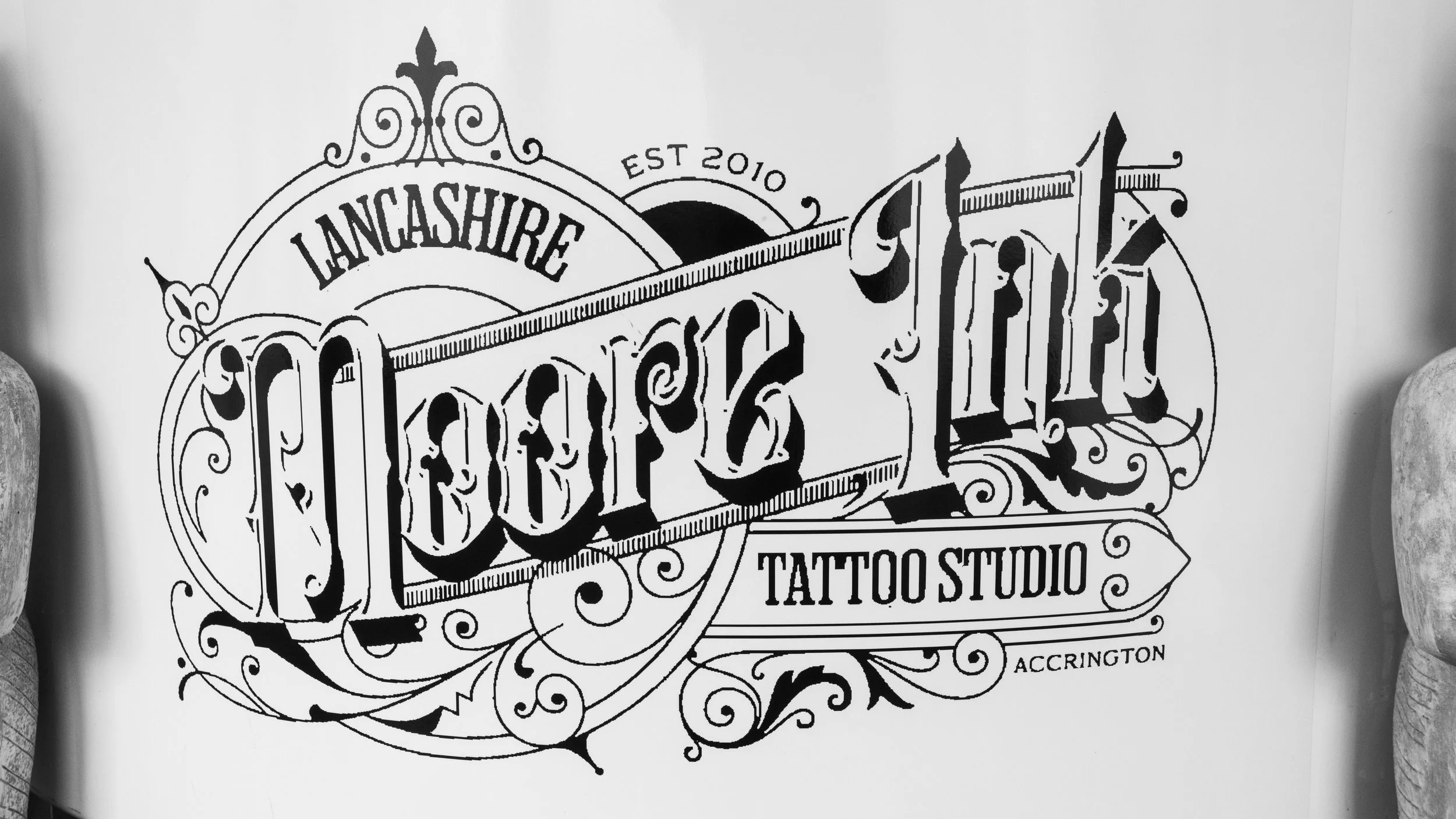 Design for Lancashhire Tattoo Studio, established in 2010, with intricate black line art and decorative flourish elements.