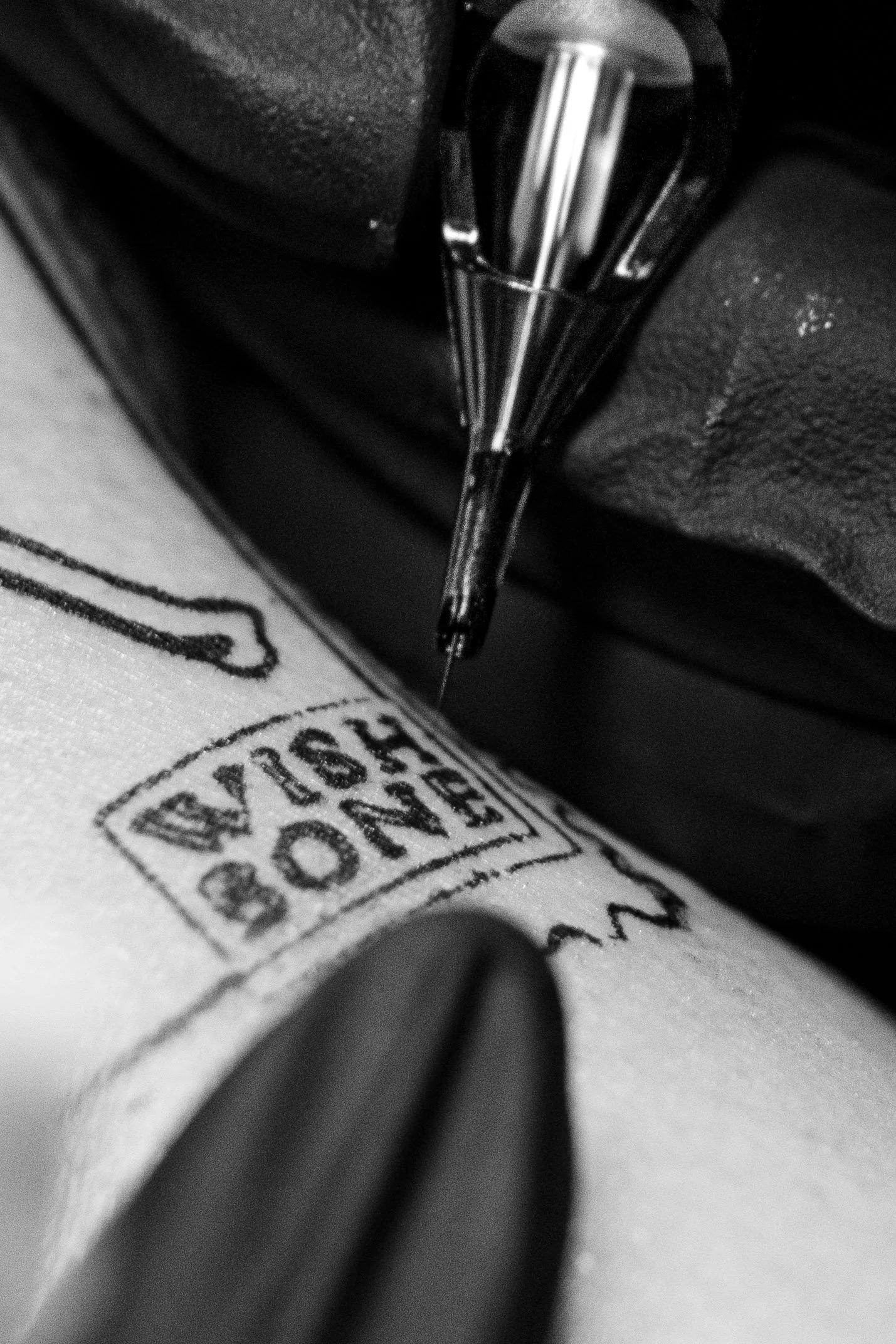 Close-up black and white photo of a printed label or stamp on a paper or document, with a portion of the text 'WASHINGTON' visible.