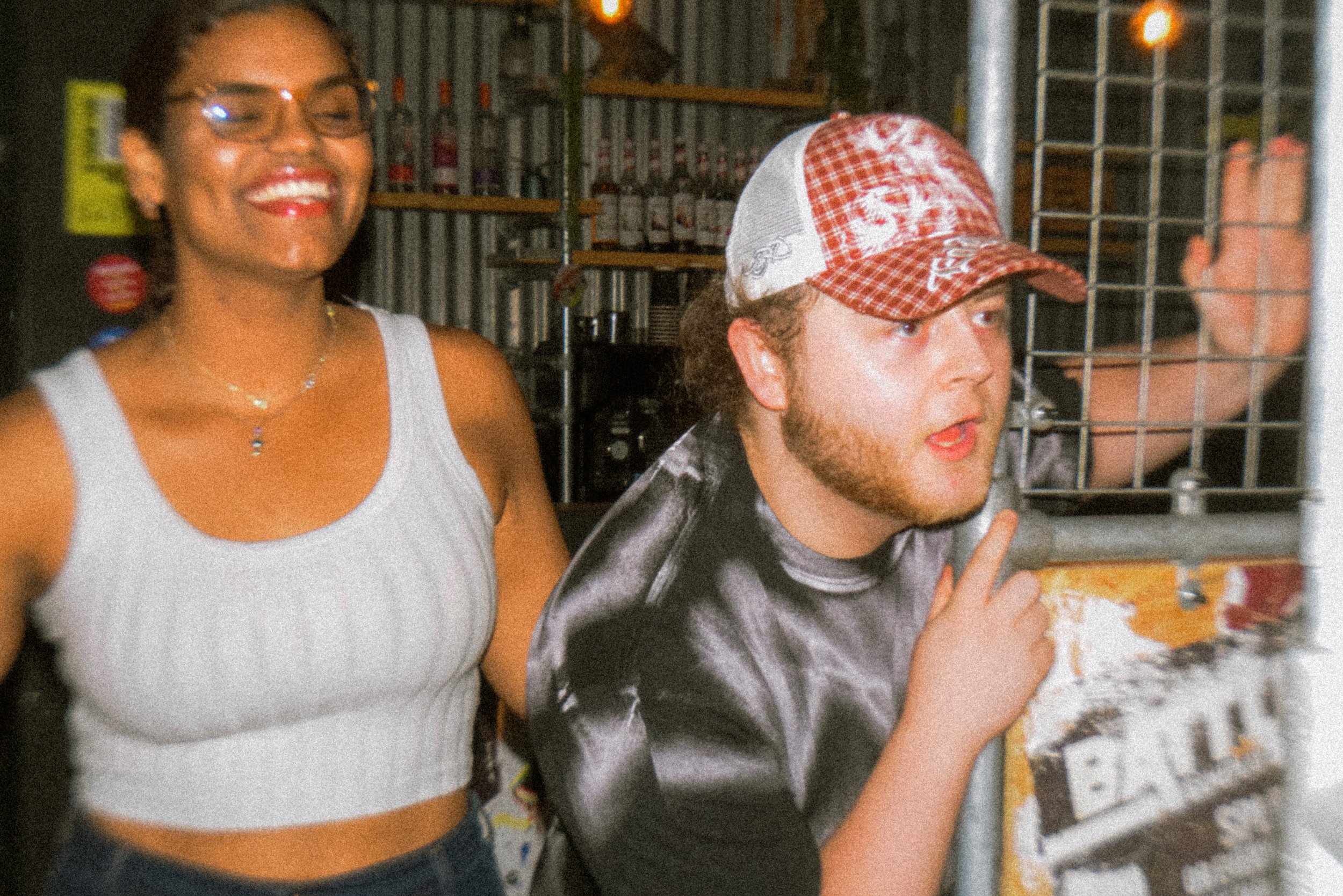 Two spectators look at axe throwing with surprise