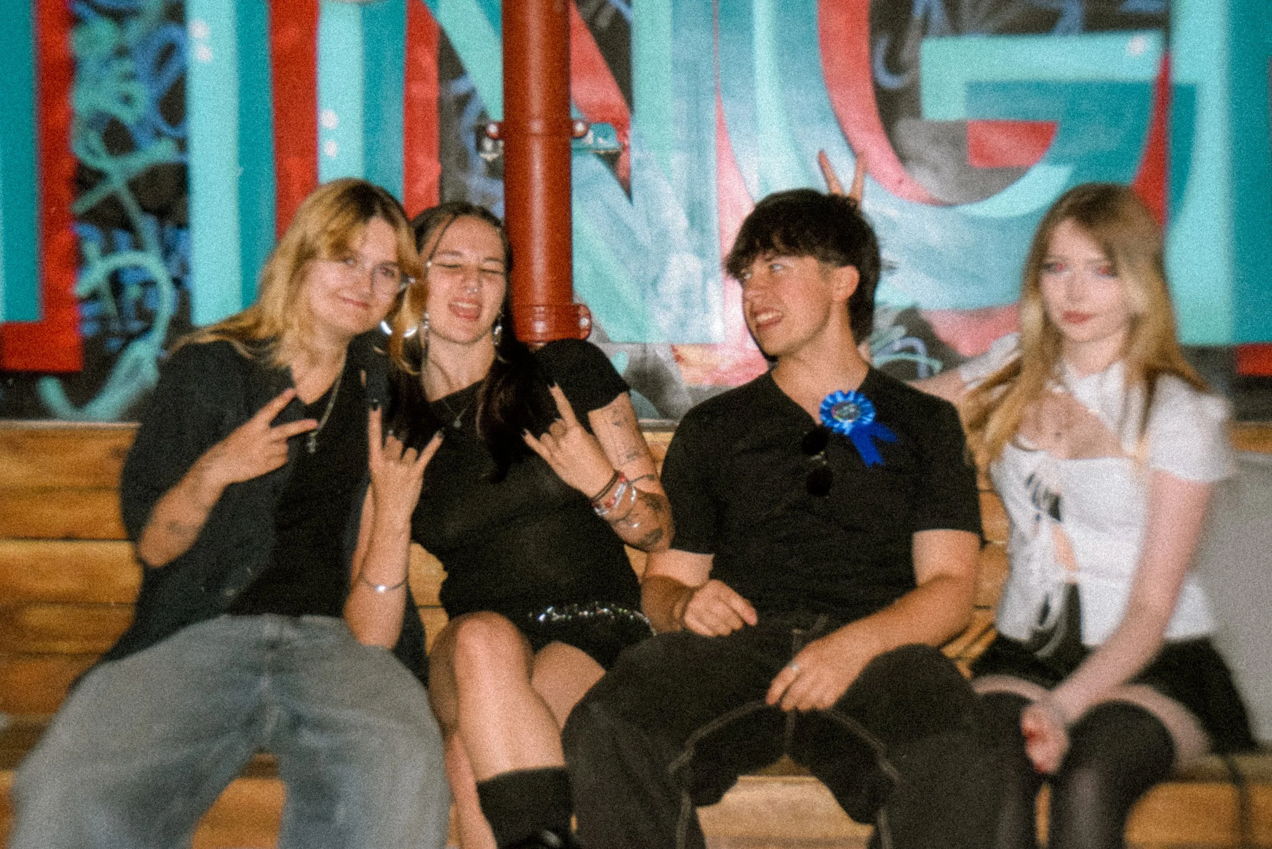 A young group of adults smiling and posing for the camera on a birthday night out