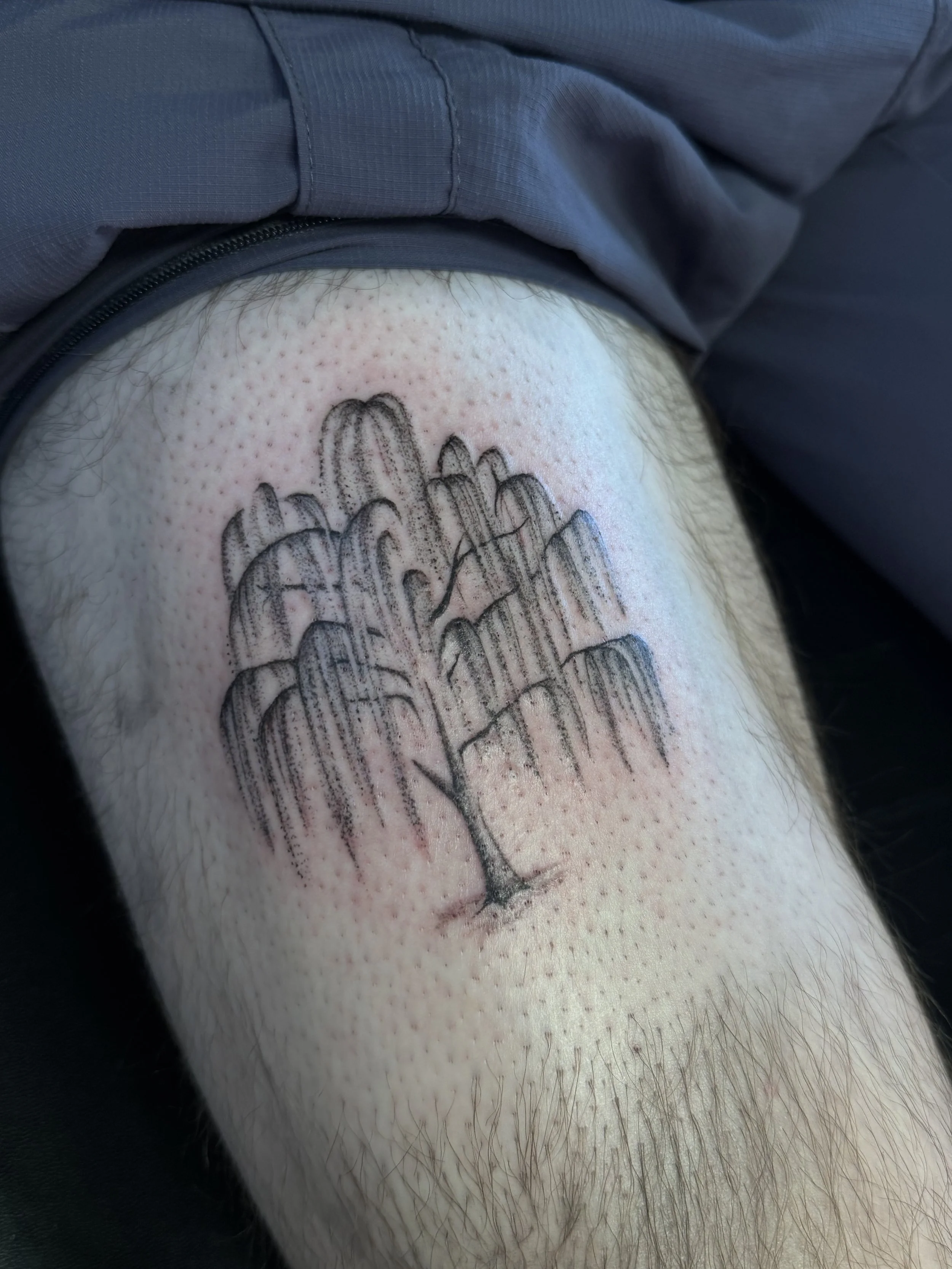 A close-up photo of a person's skin with a tattoo of a hand in a praying position. The skin appears slightly red and inflamed around the tattoo.