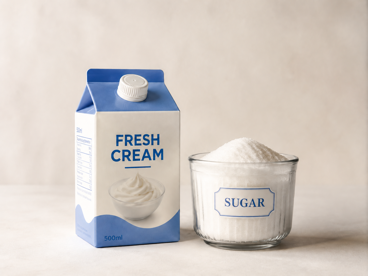 A carton of fresh cream, a glass bowl of sugar, and a pile of white granulated sugar.