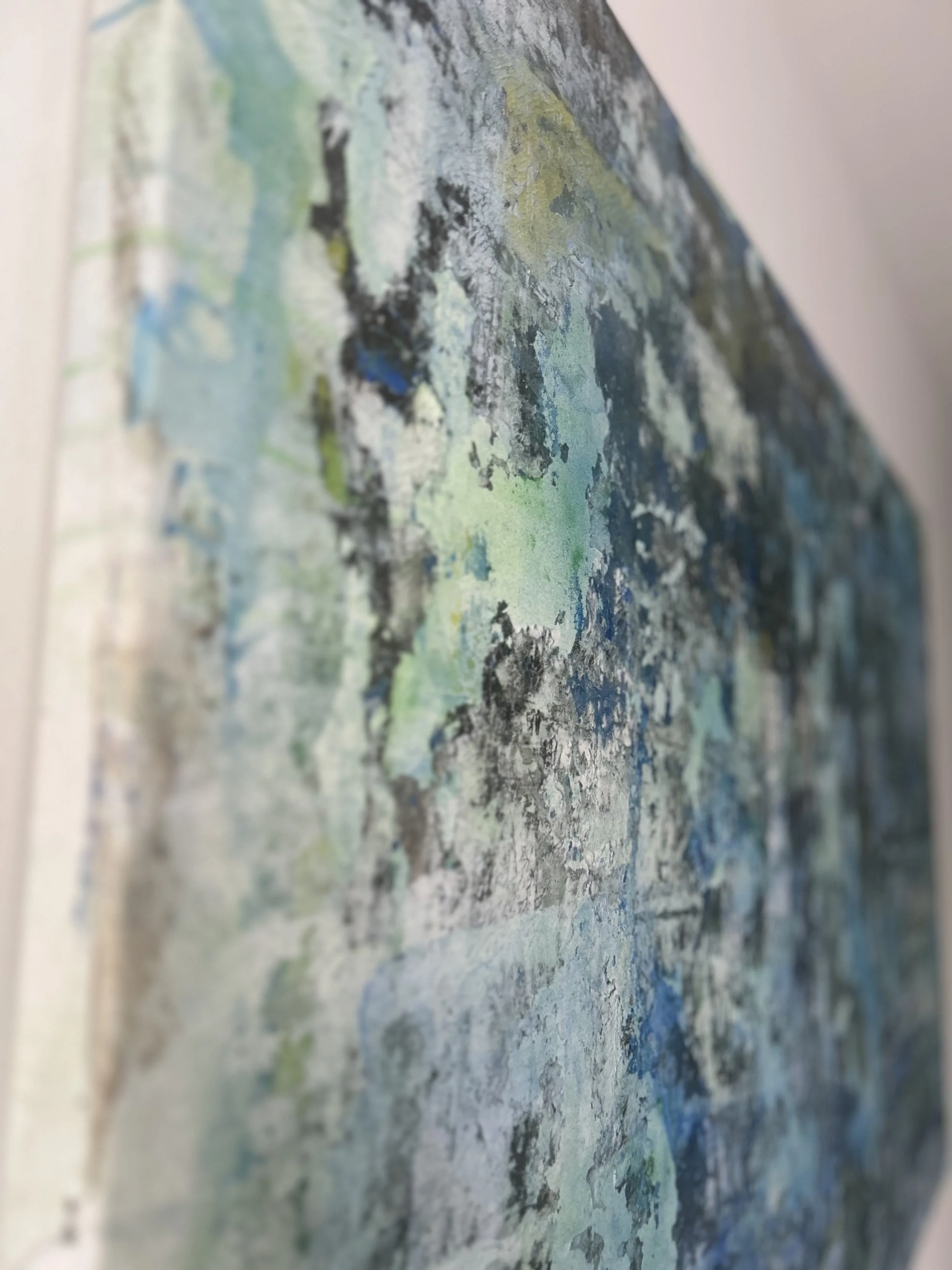 A colorful abstract painting with various shades of blue, green, black, and white, featuring textured and layered brushstrokes.