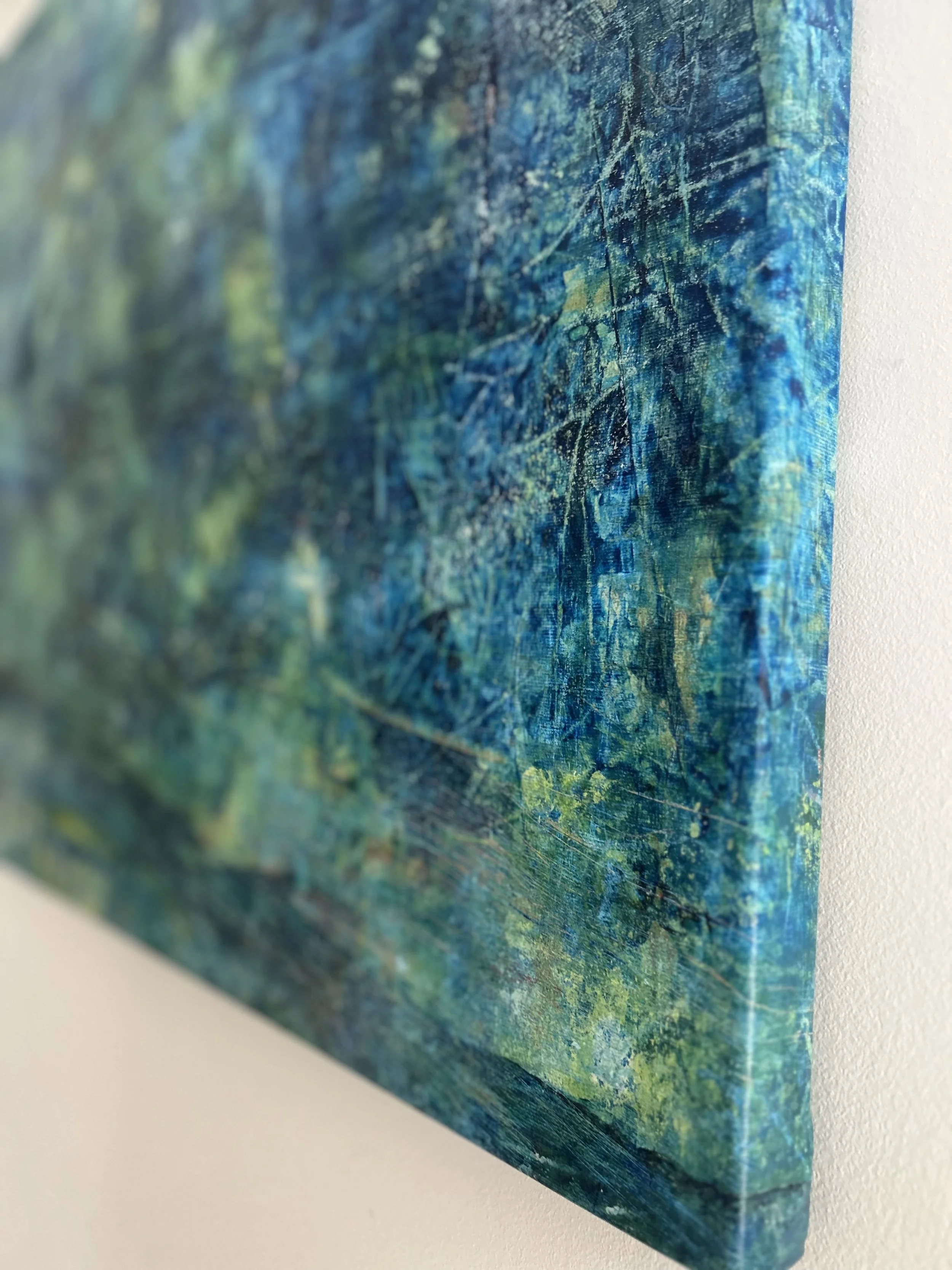 Close-up of an abstract painting with predominantly blue and green colors, textured surface, and visible brushstrokes.