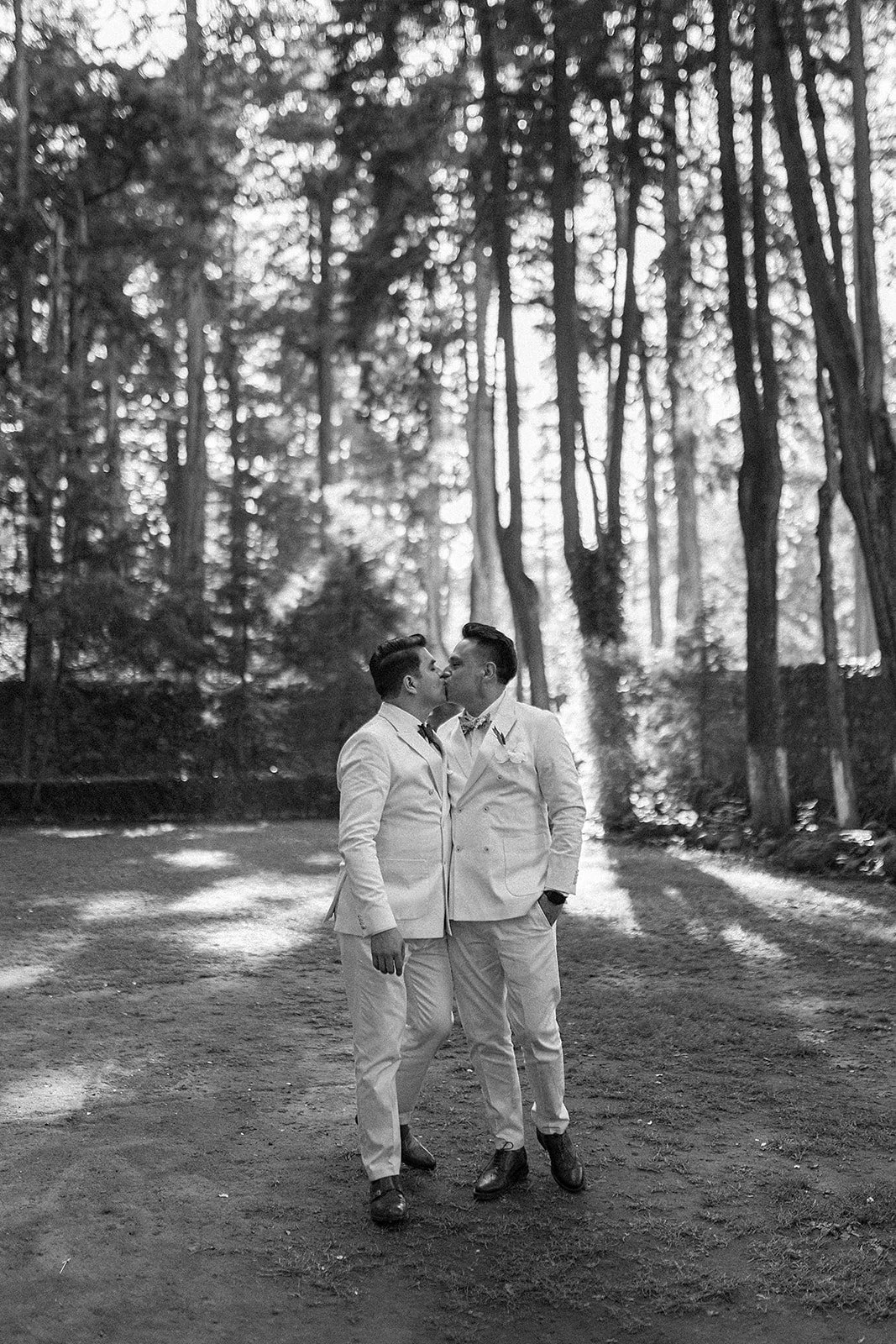 two men wearing white kissing.jpg