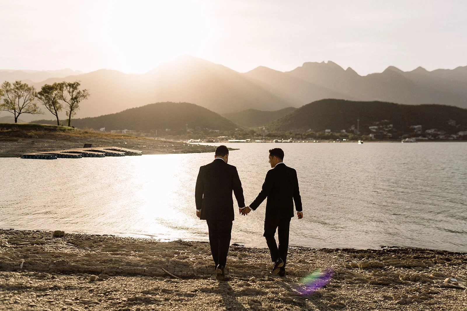 two men holding hands wedding.jpg