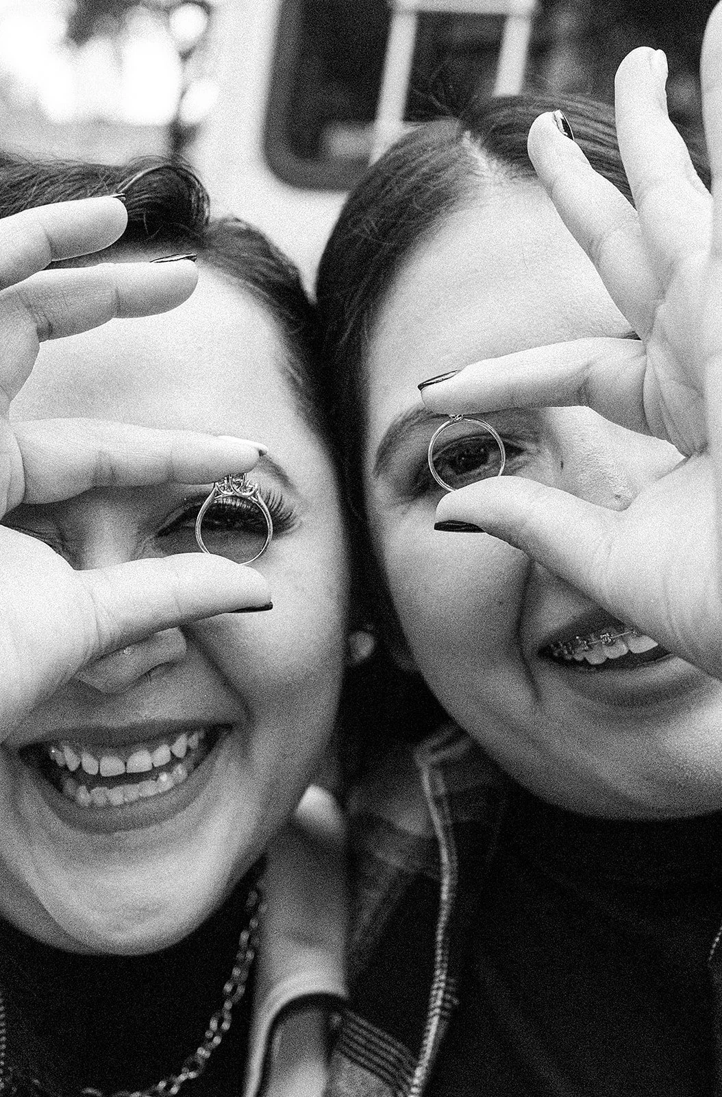 two women holding wedding rings.jpg