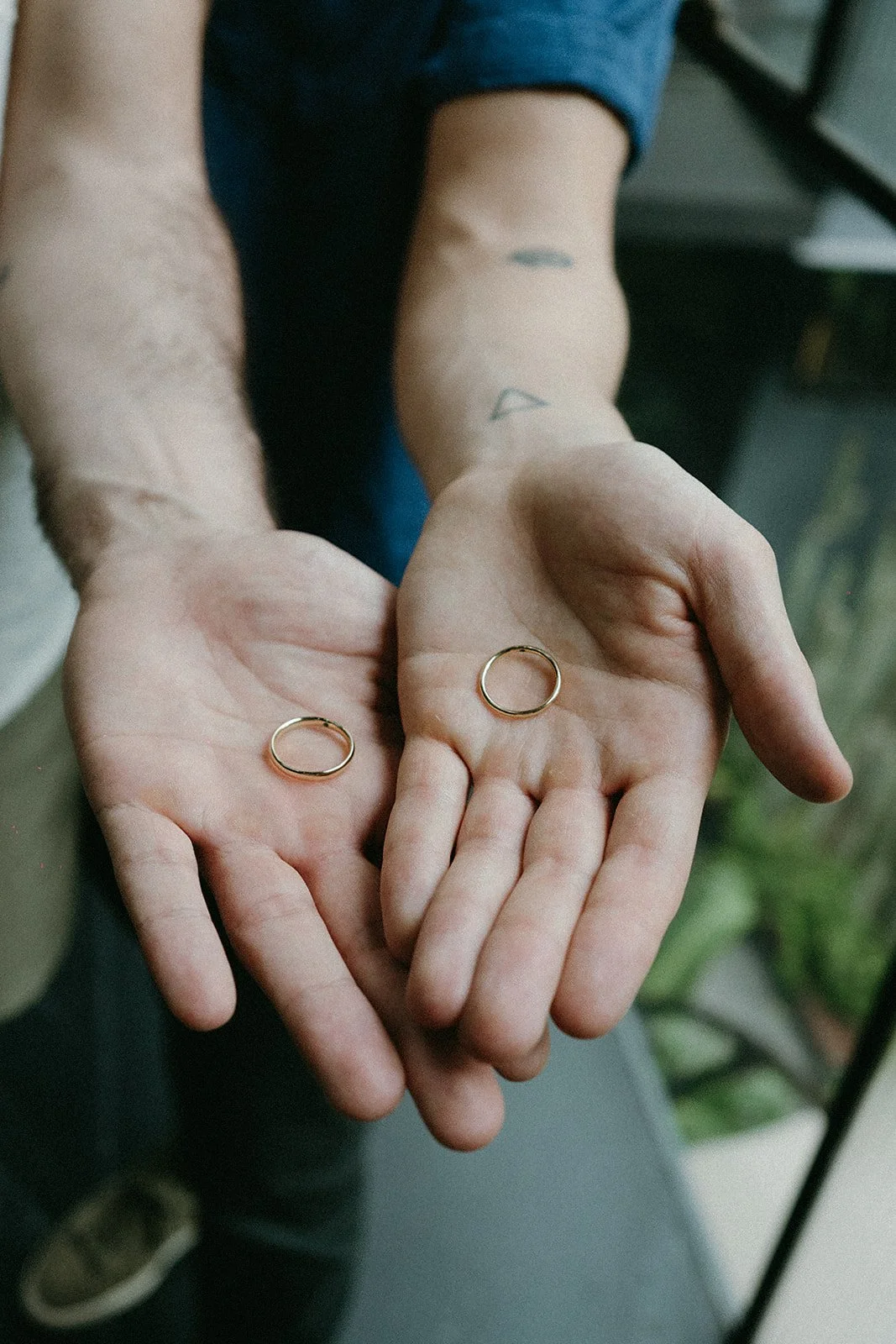 two hands holding weddding rings.jpg