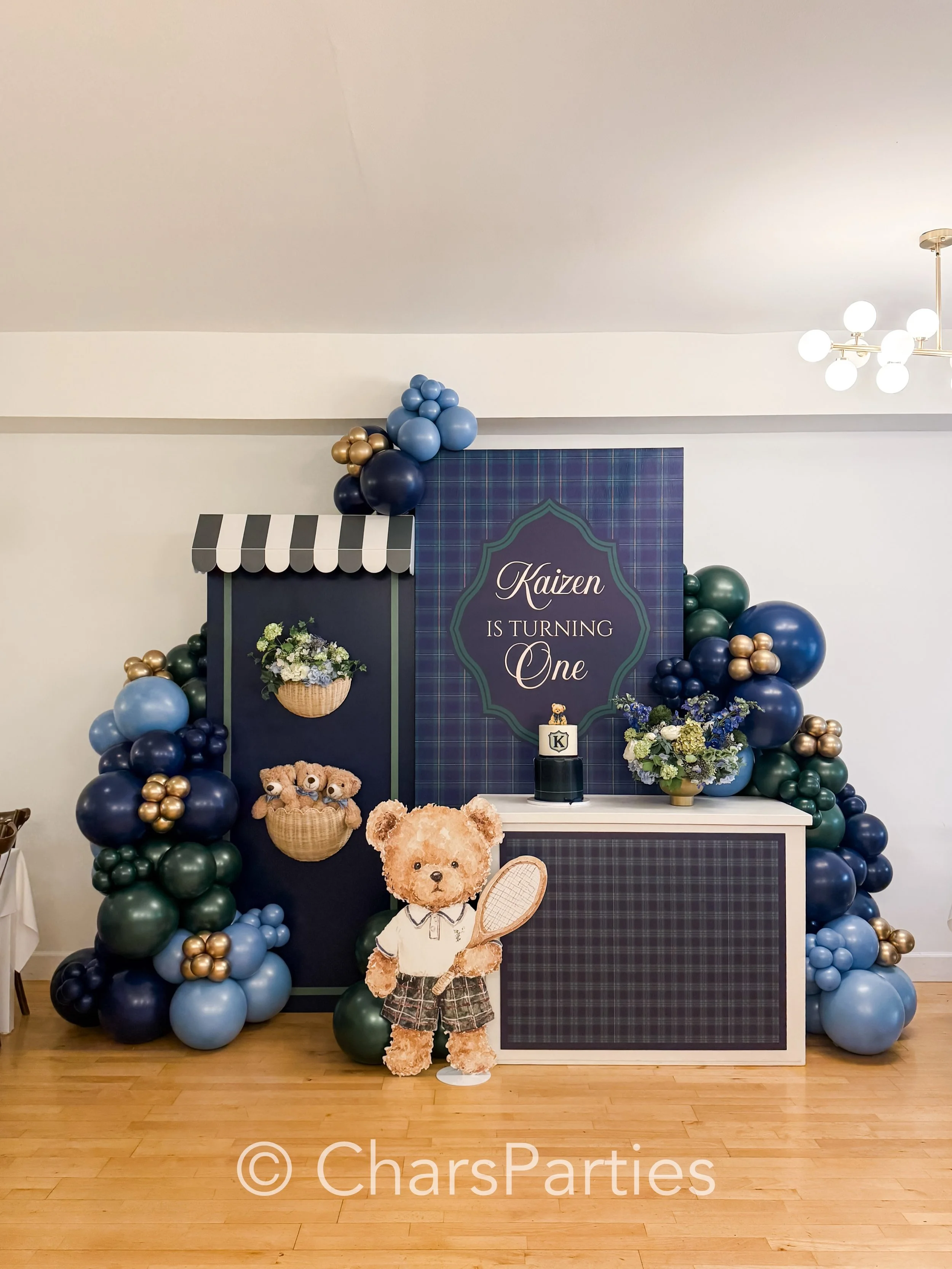 A classic theme with a modern, preppy twist. 🧸

When our client asked for a teddy bear theme, we wanted to elevate it into something truly unique. We paired rich deep navy, hunter green, and soft blues with timeless plaid patterns and a vintage coun