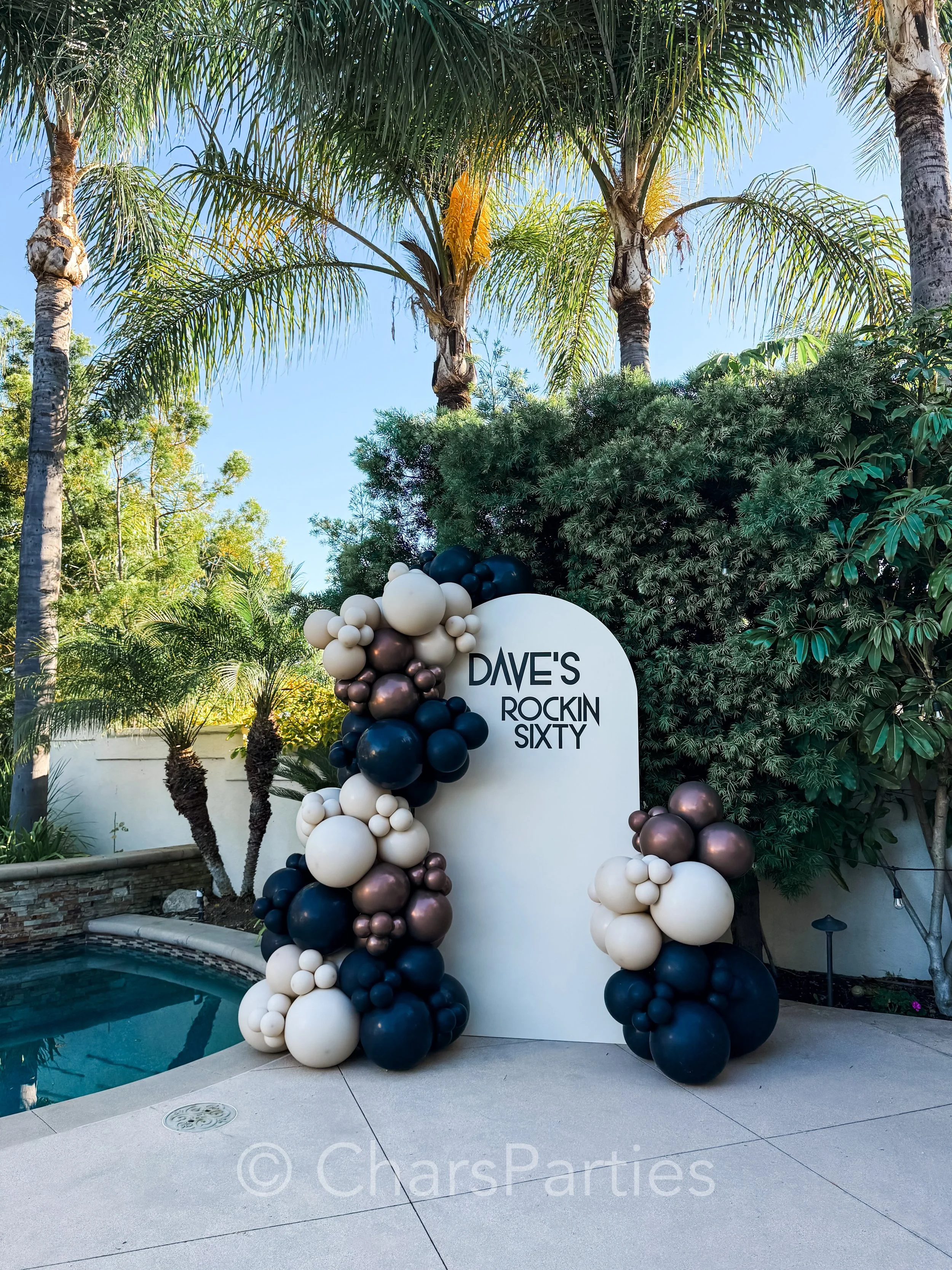 Dave&rsquo;s Rockin&rsquo; Sixty 🤘🎸

A milestone moment deserves a statement &ndash; even when the celebration space is intimate. We transformed a small poolside patio with a custom backdrop, an organic balloon installation in black, white sand and