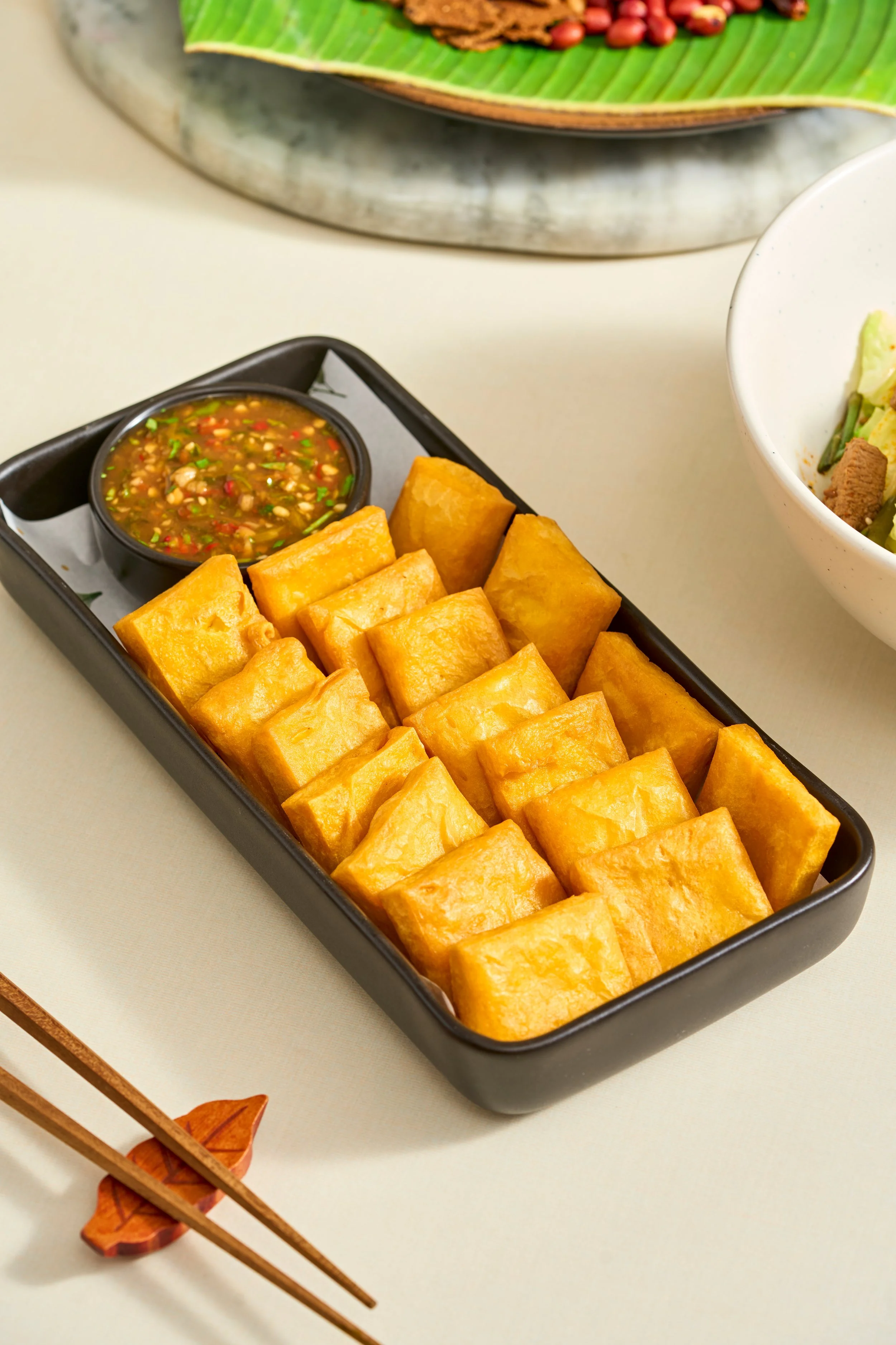TOFU KYAW (Crispy Burmese Shan Tofu)

Made entirely from scratch using pure yellow split peas, this dish celebrates the unique chickpea-tofu traditions of the Shan State highlanders. Deep-fried to a flawless golden brown, it is crunchy on the outside