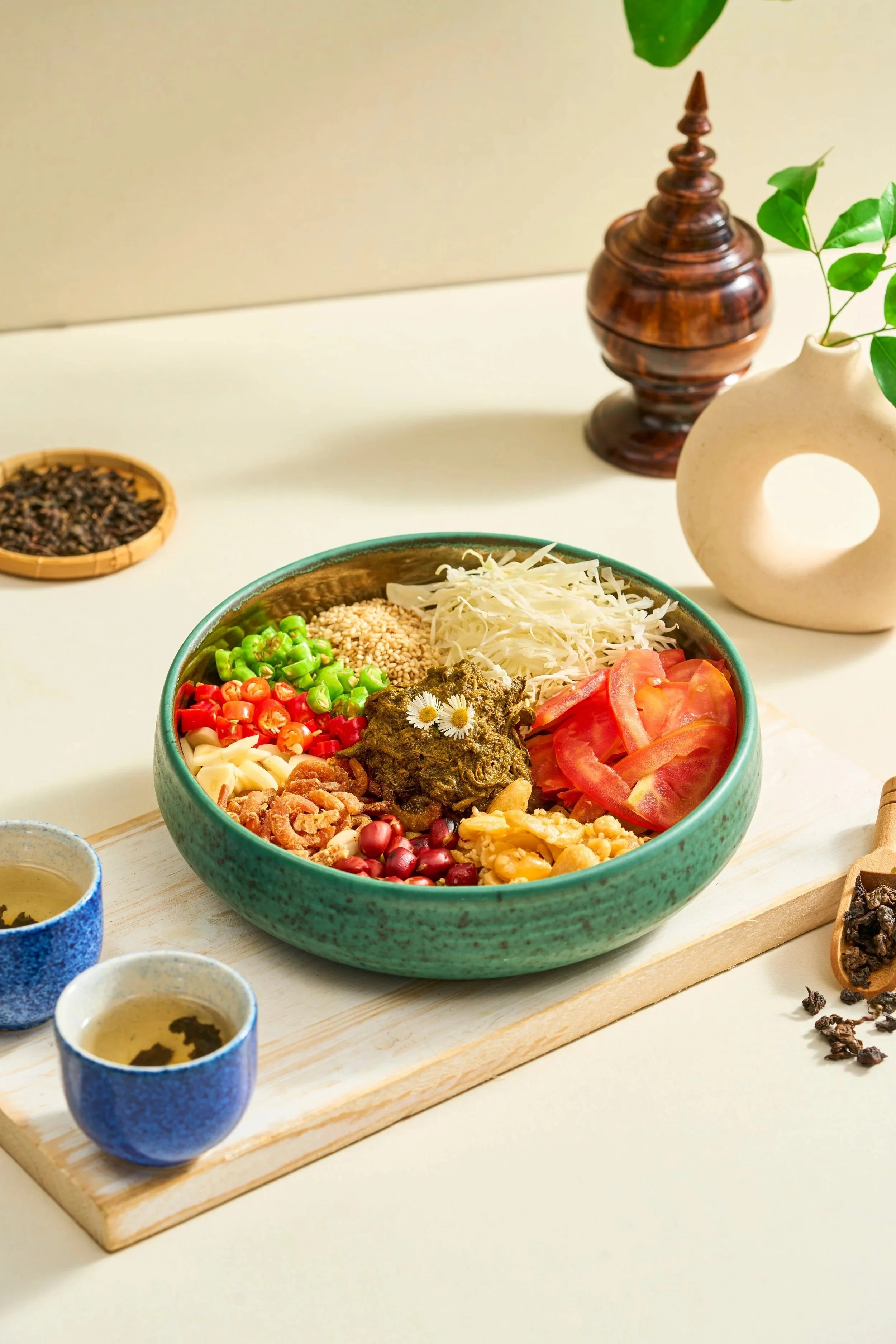 LAHPET THOKE (Burmese Tea Leaf Salad)

The cornerstone of Myanmar’s hospitality culture, this iconic salad features premium fermented tea leaves tossed with a crunchy texture of toasted lentils, crisp fried garlic, sesame seeds, and peanuts. It deliv