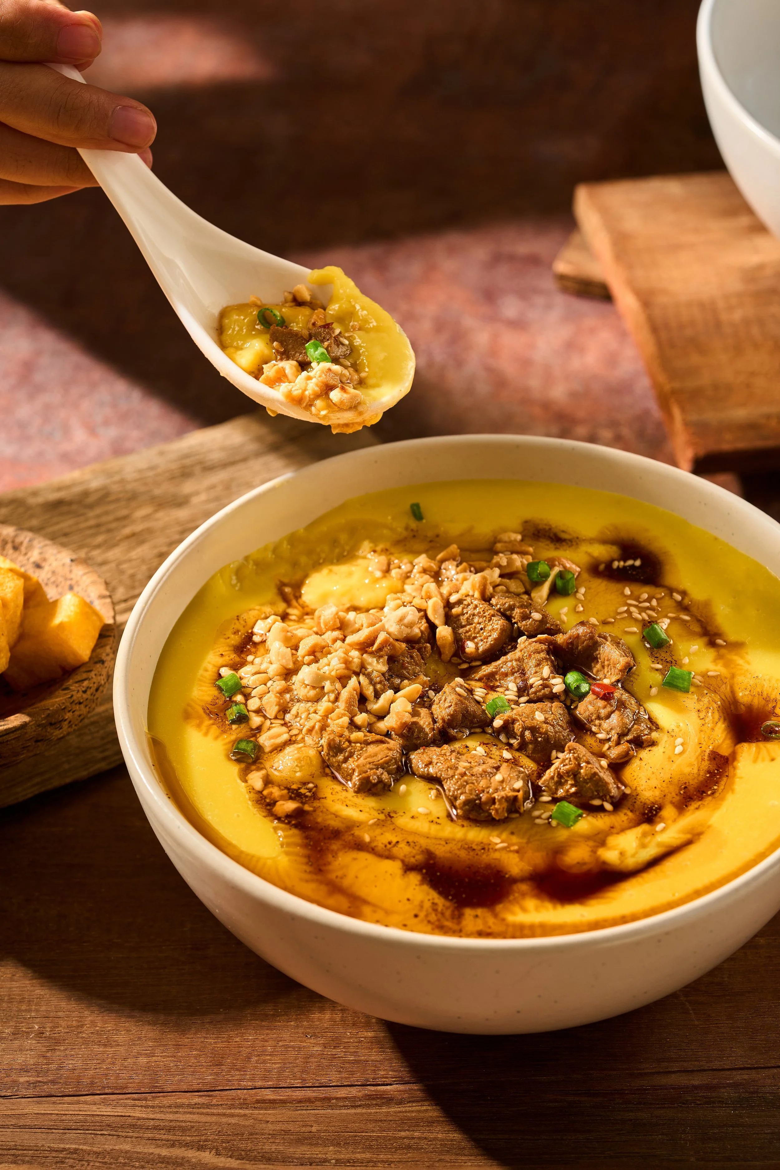 Tofu Nway (Warm Tofu Noodle Soup)

A comforting morning gem from the Shan mountains, showcasing the pure magic of artisanal chickpea cream. Tender flat rice noodles are submerged in a thick, velvety, warm puree of fresh yellow split peas, elegantly d
