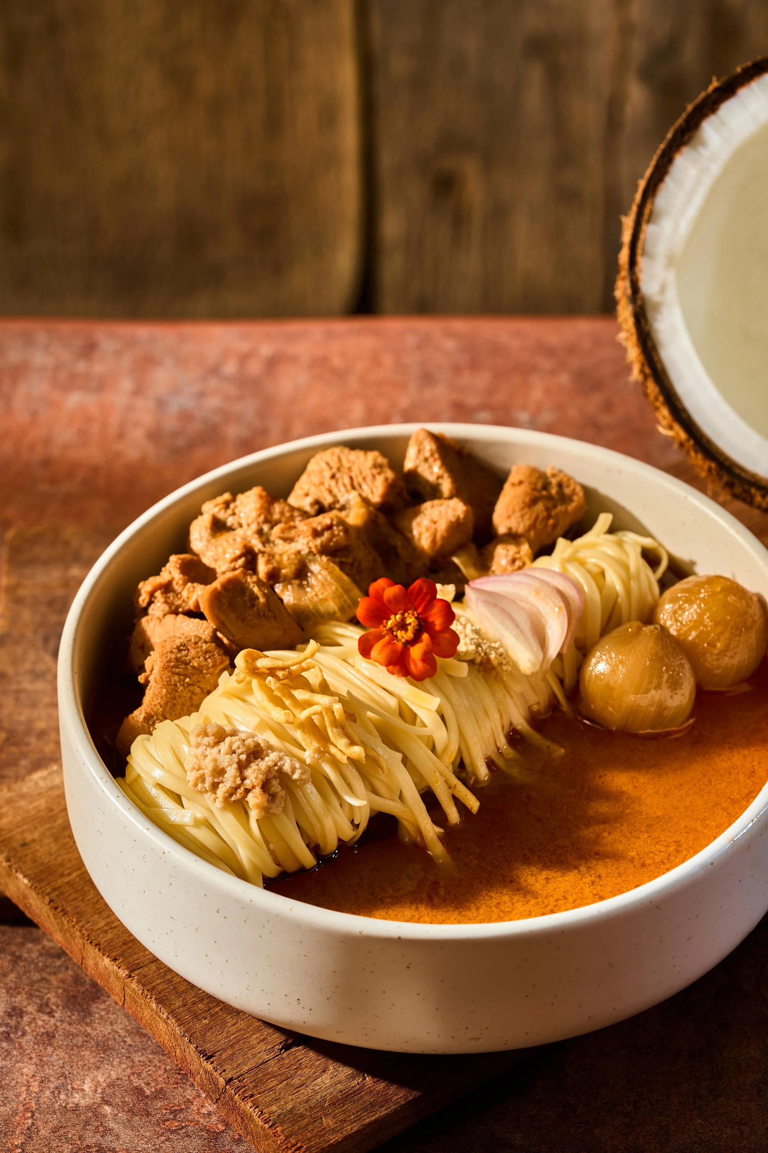 SHWE TAUNG NOODLE (Coconut Chicken Curry Noodle)

A festive, joyous classic from Central Myanmar traditionally prepared for celebratory family gatherings. Chewy wheat noodles are bathed in a rich, velvety, aromatic chicken curry broth reduction infus