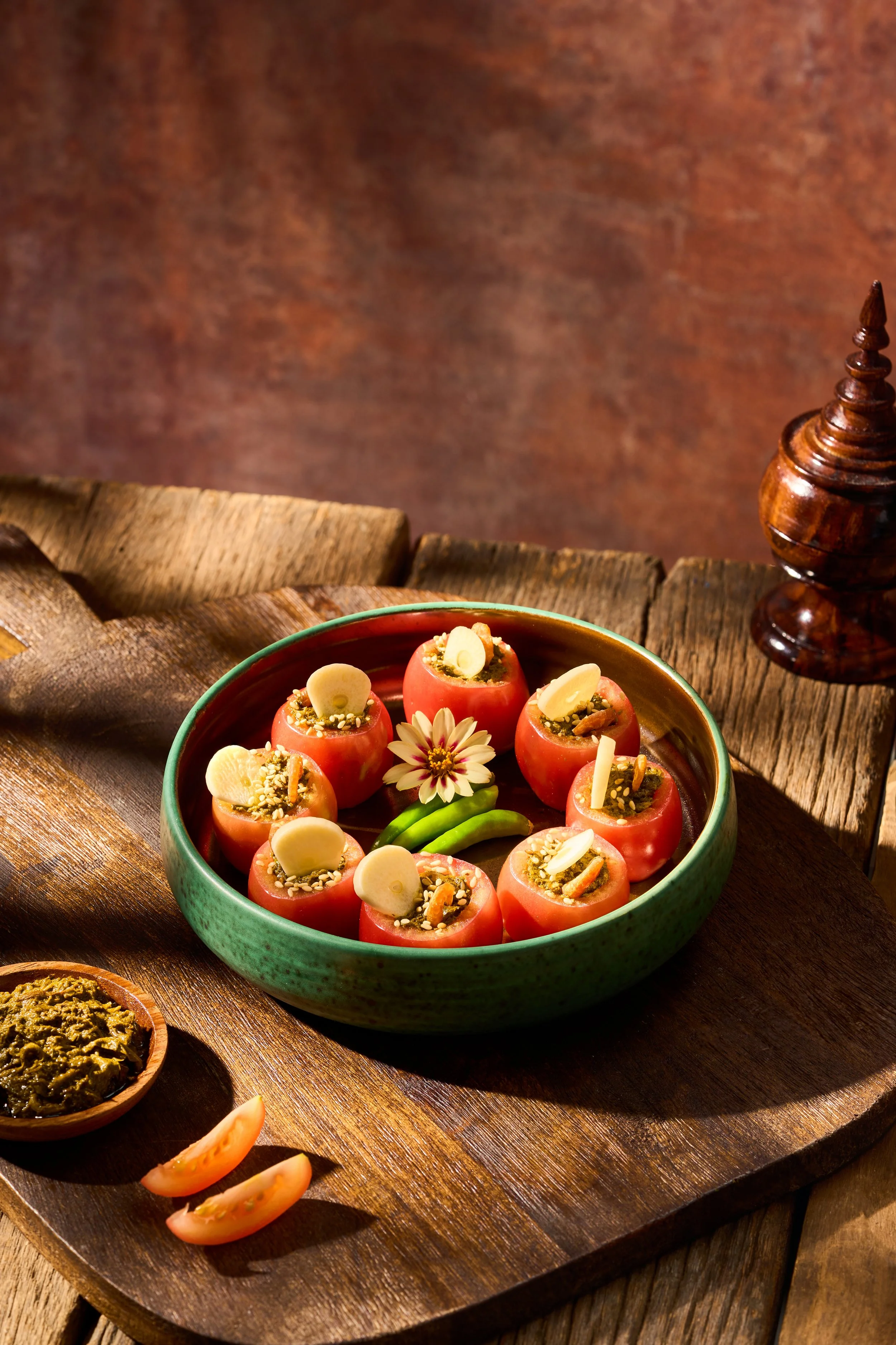 TOMATOES STUFFED LAHPET (Lahpet-Stuffed Tomatoes)

An elegant, artistic reimagining of the traditional tea leaf salad, transforming rustic flavors into a refined presentation. Ripe vine tomatoes are hollowed and stuffed with a finely minced, seasoned