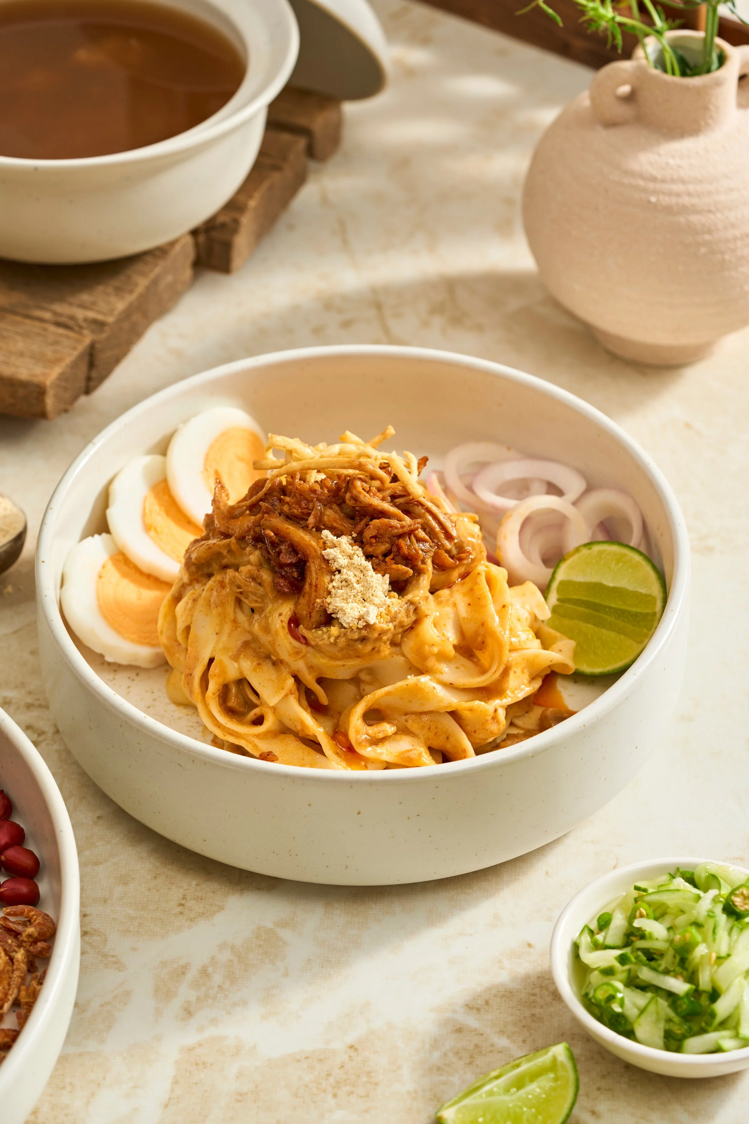 NAN PYAR THOKE (Flat Rice Noodle Salad)

A celebrated street-style classic showcasing the intricate art of Burmese hand-tossed noodle culture. Wide, flat rice noodles are masterfully combined with tender seasoned chicken, raw red onions, toasted chic
